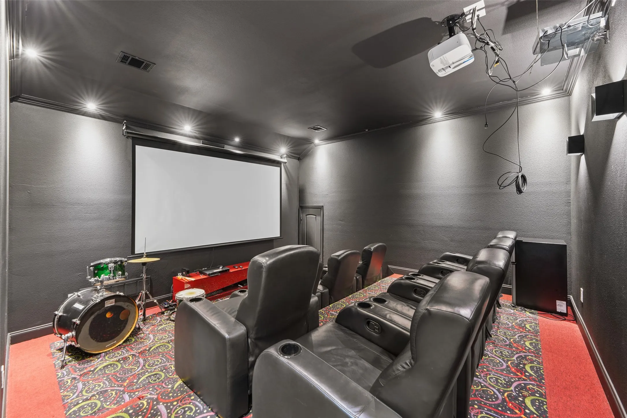 Carpeted home theater with a textured wall