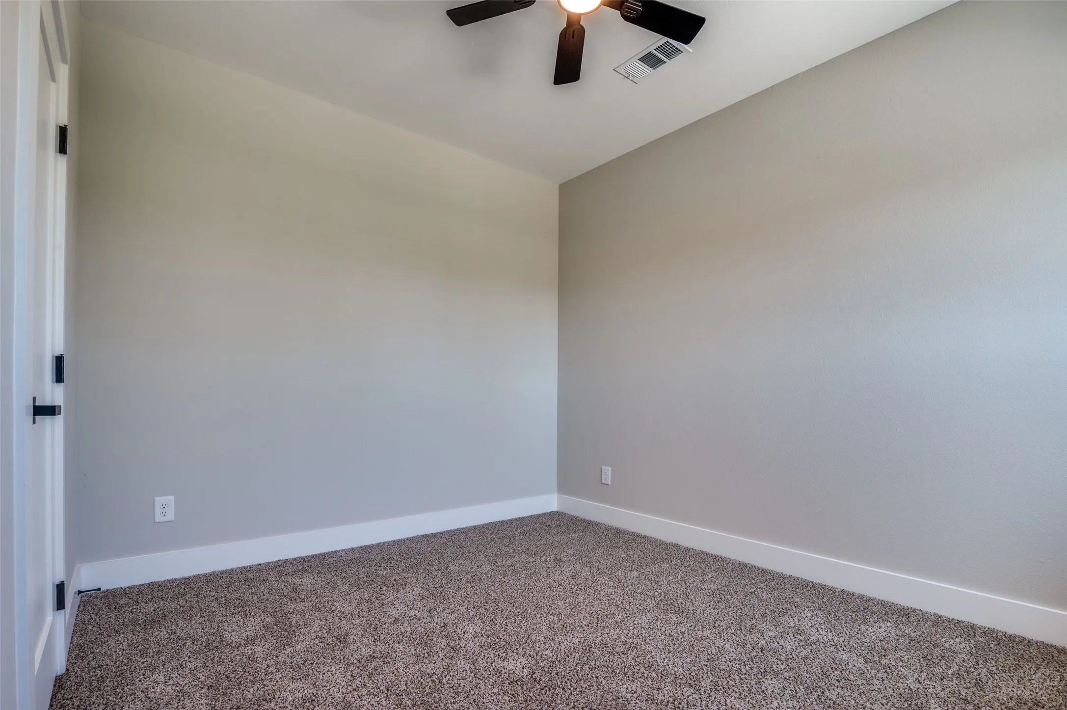 View of guest bedroom with ceiling fans for comfort