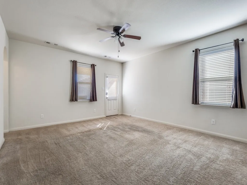 Spare room featuring carpet flooring and ceiling fan