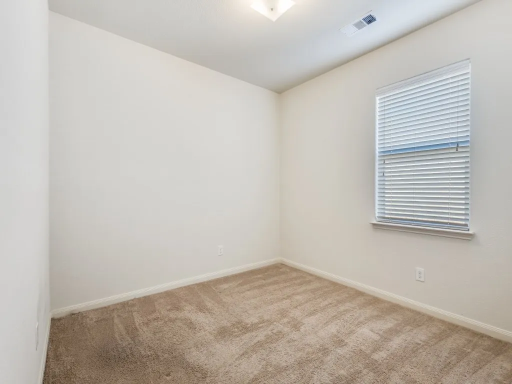 Spare room with carpet and baseboards
