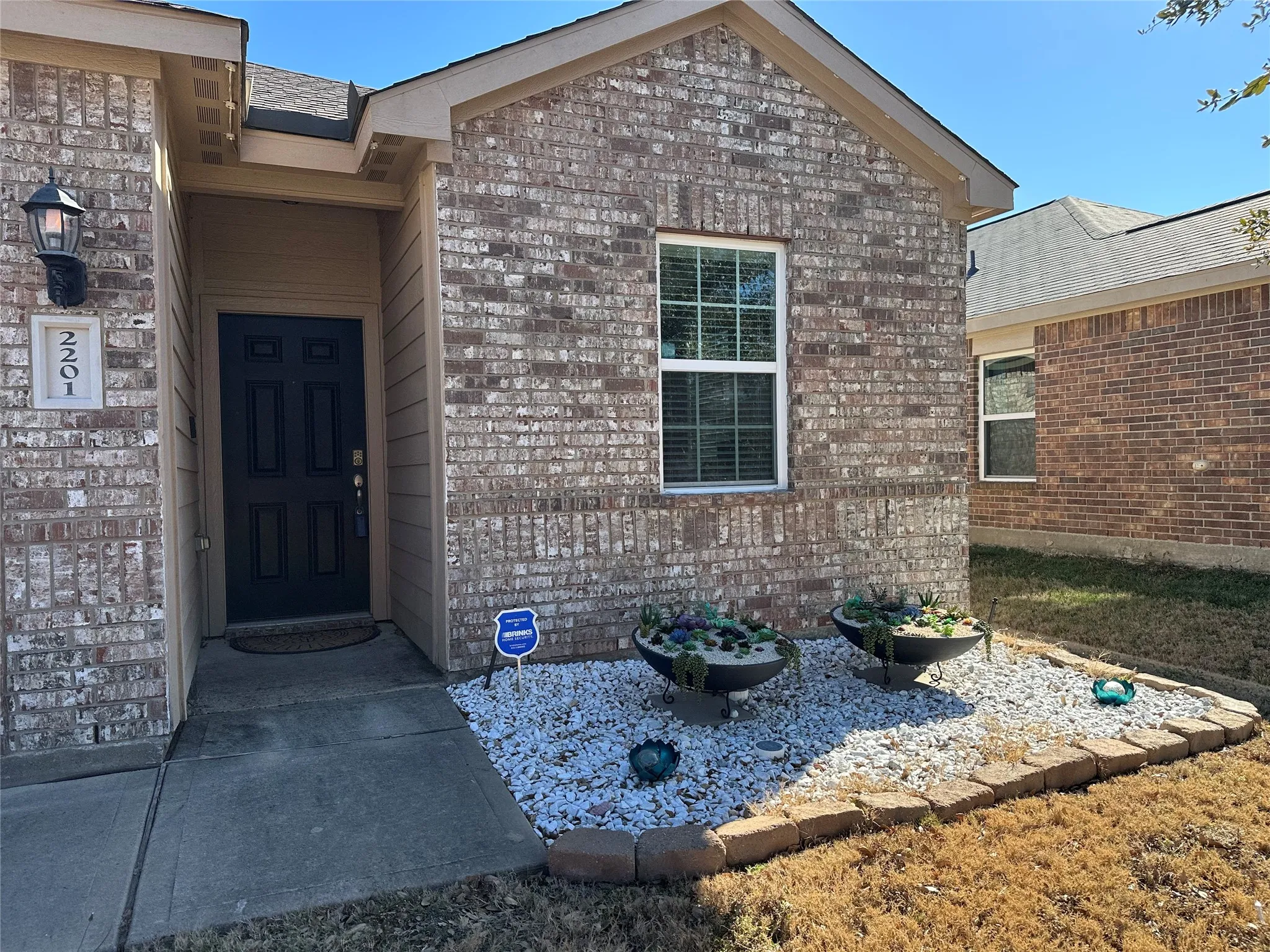Property entrance featuring brick siding