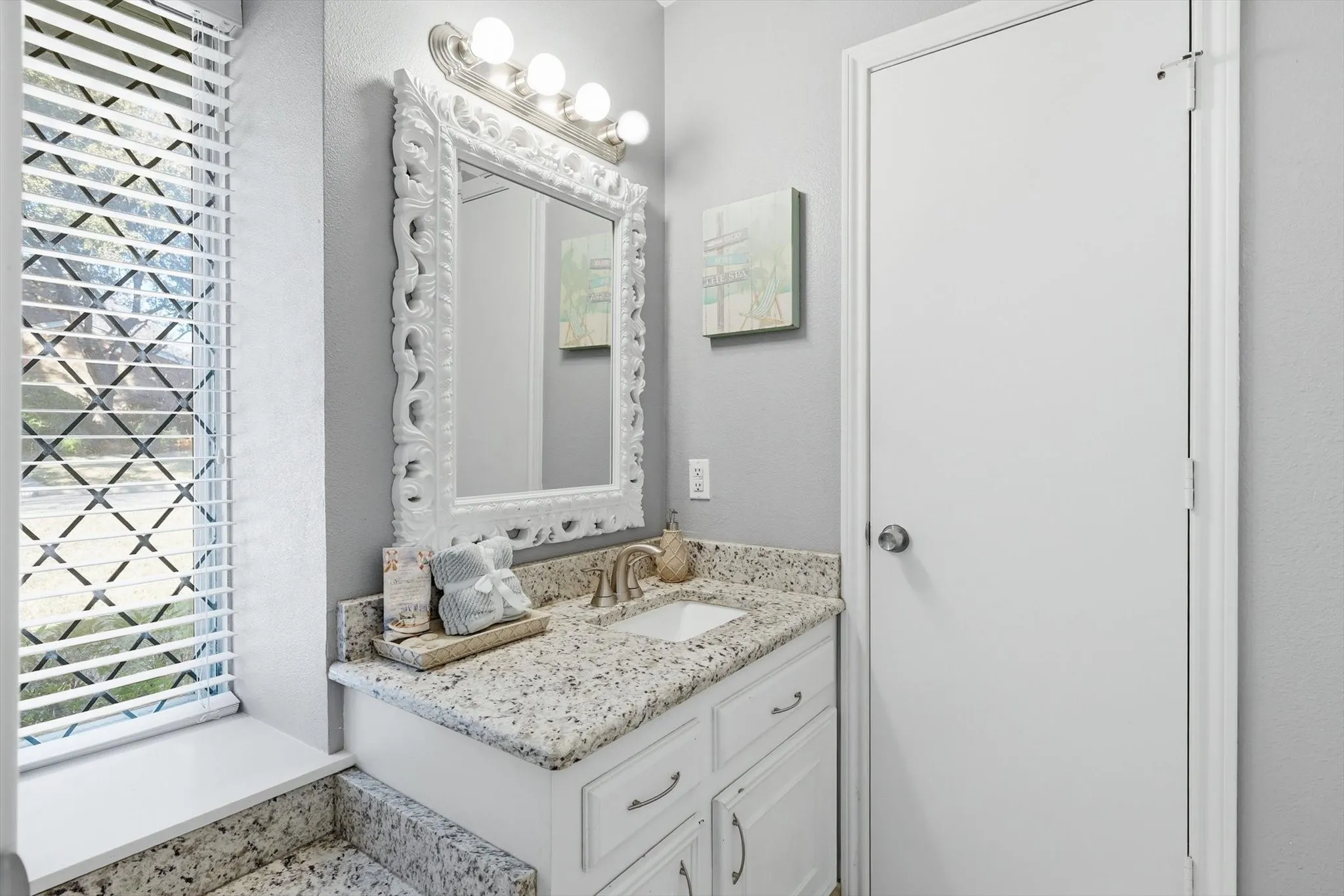Private vanity connected to second bedroom, including a linen closet for storage space