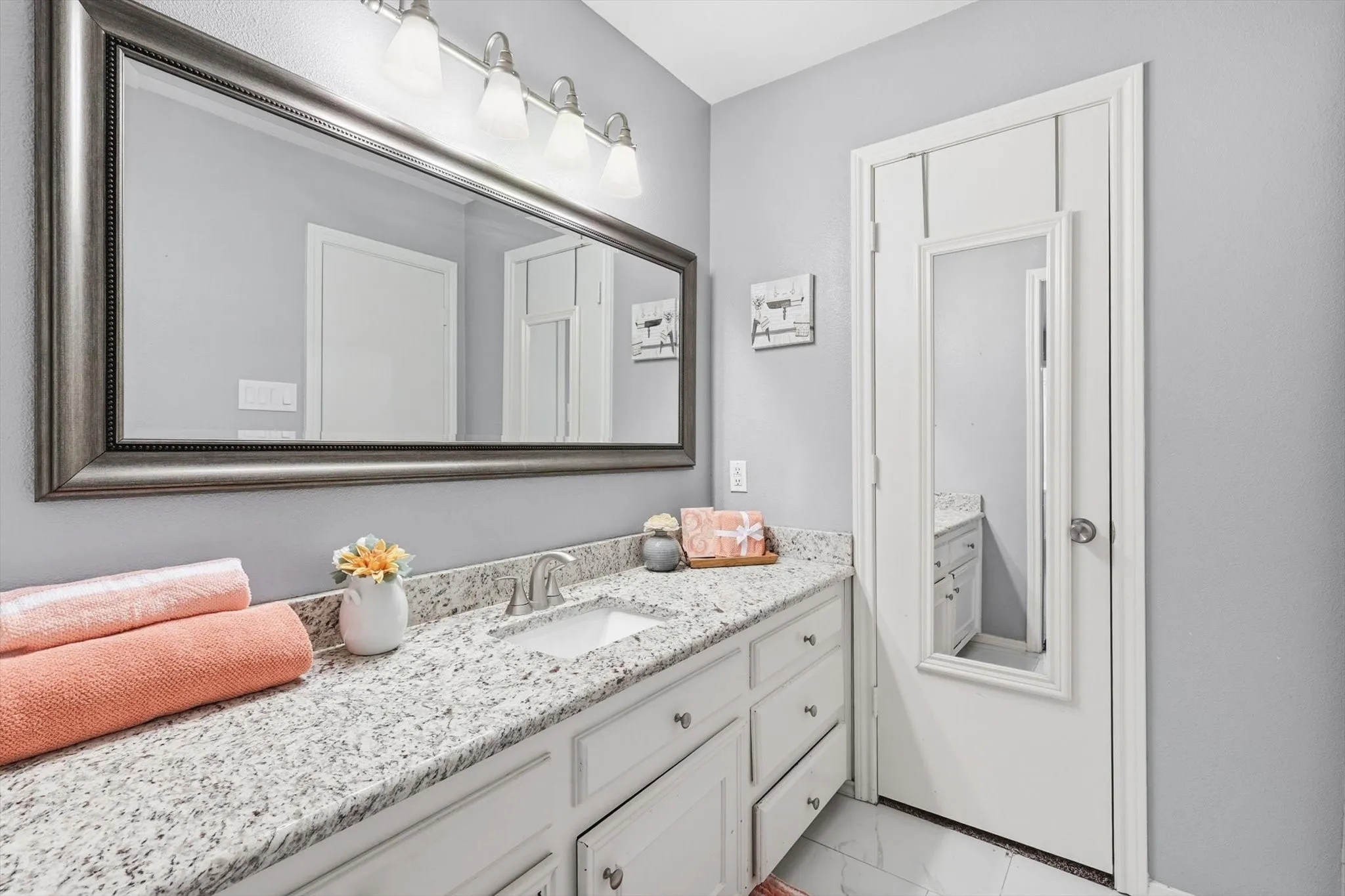 Dual vanities offer convenience and privacy in this well-appointed ensuite.