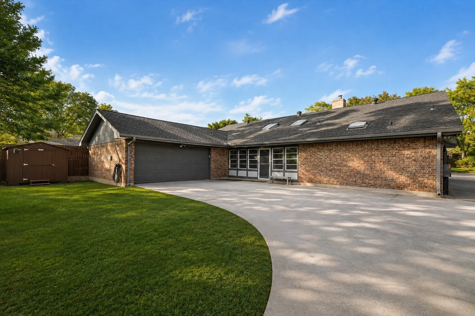 Expansive gated driveway offering privacy and plenty of parking.