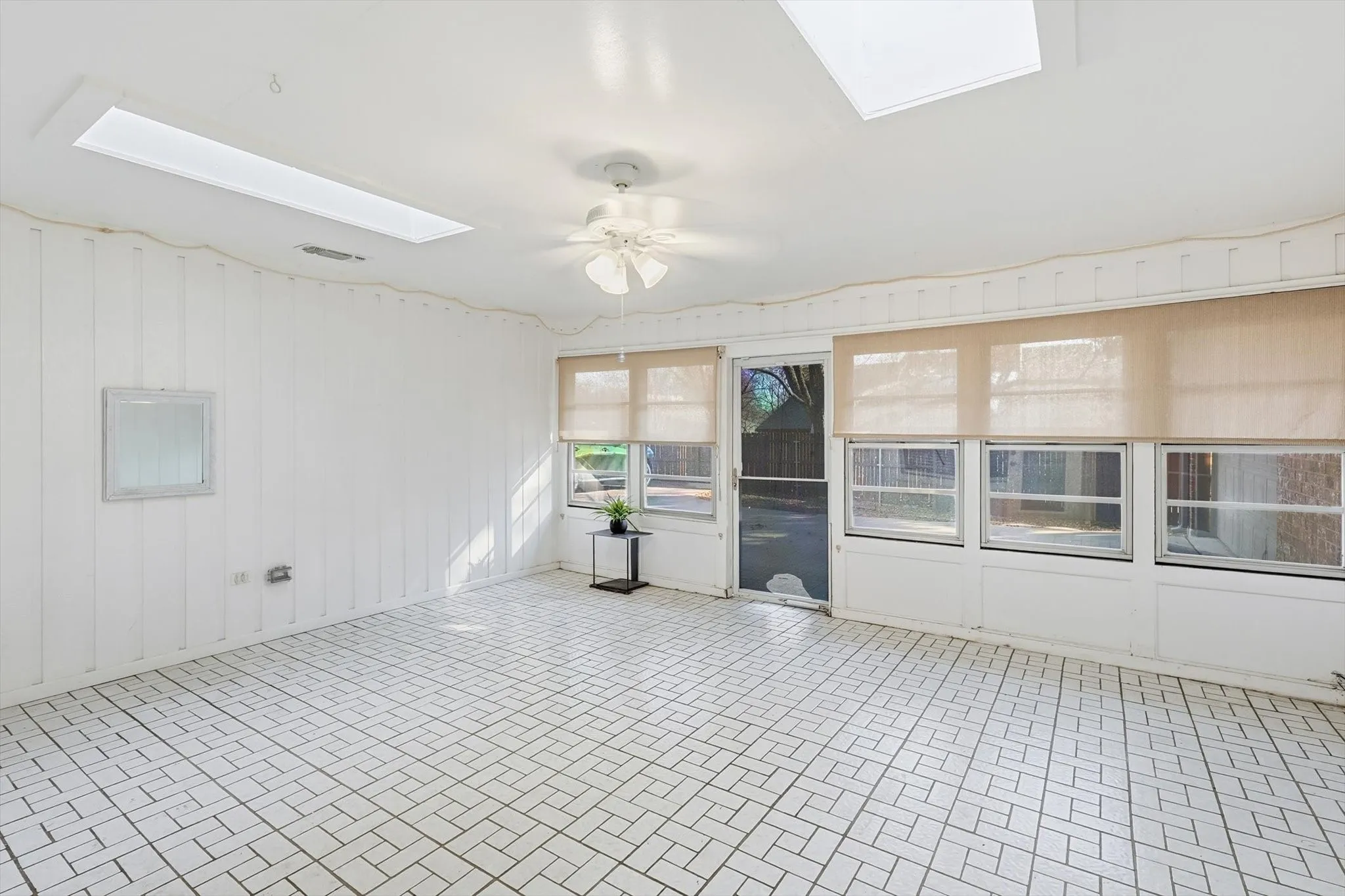 Bright sunroom enhanced by a skylight for beautiful natural light.