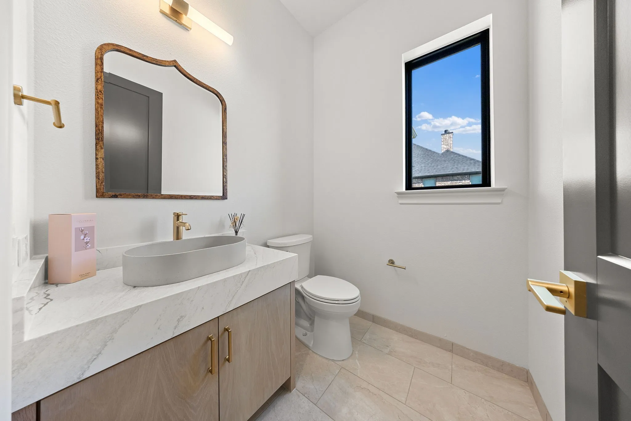 Modern vanity with a vessel sink, stone countertop, and wood-finish cabinetry