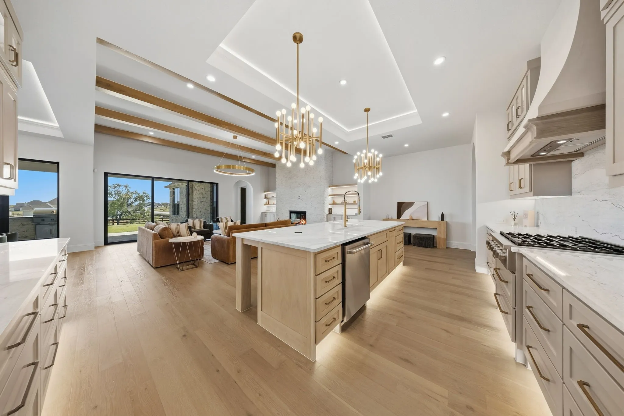 Expansive kitchen with an oversized island, integrated stainless steel appliances, and abundant cabinetry