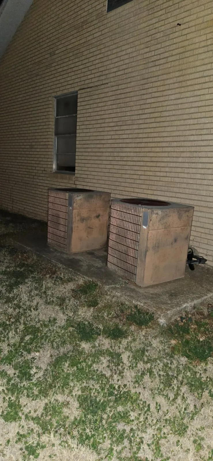 View of side of home with a central AC unit
