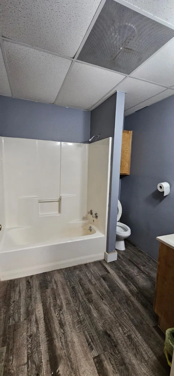 Full bath featuring tub / shower combination, vanity, a paneled ceiling, and dark wood-style floors