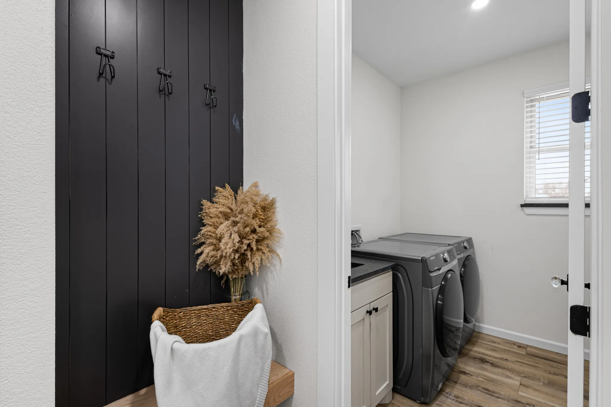 Mud Room with bench leading into laundry room