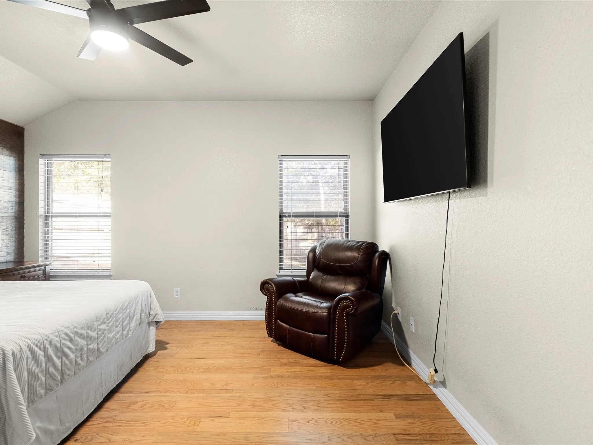 Bedroom featuring light wood-type flooring, a ceiling fan, and vaulted ceiling