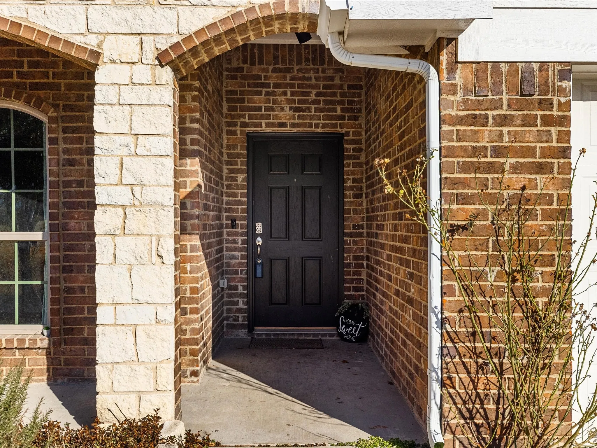 View of exterior entry with brick siding