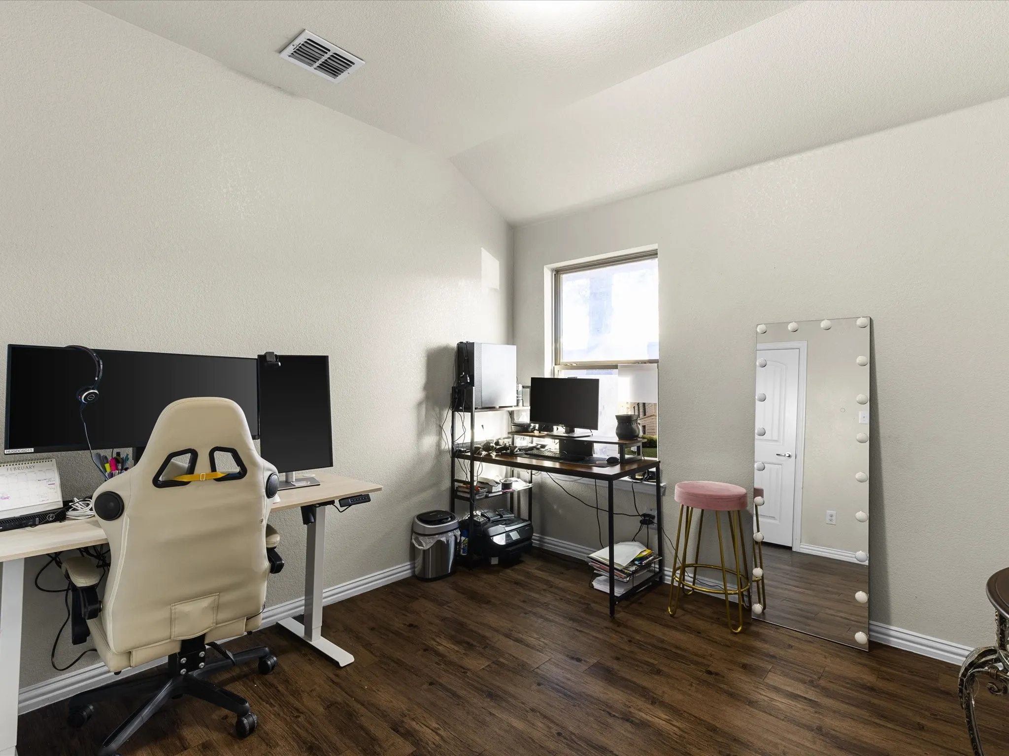 Office space featuring vaulted ceiling and dark wood finished floors
