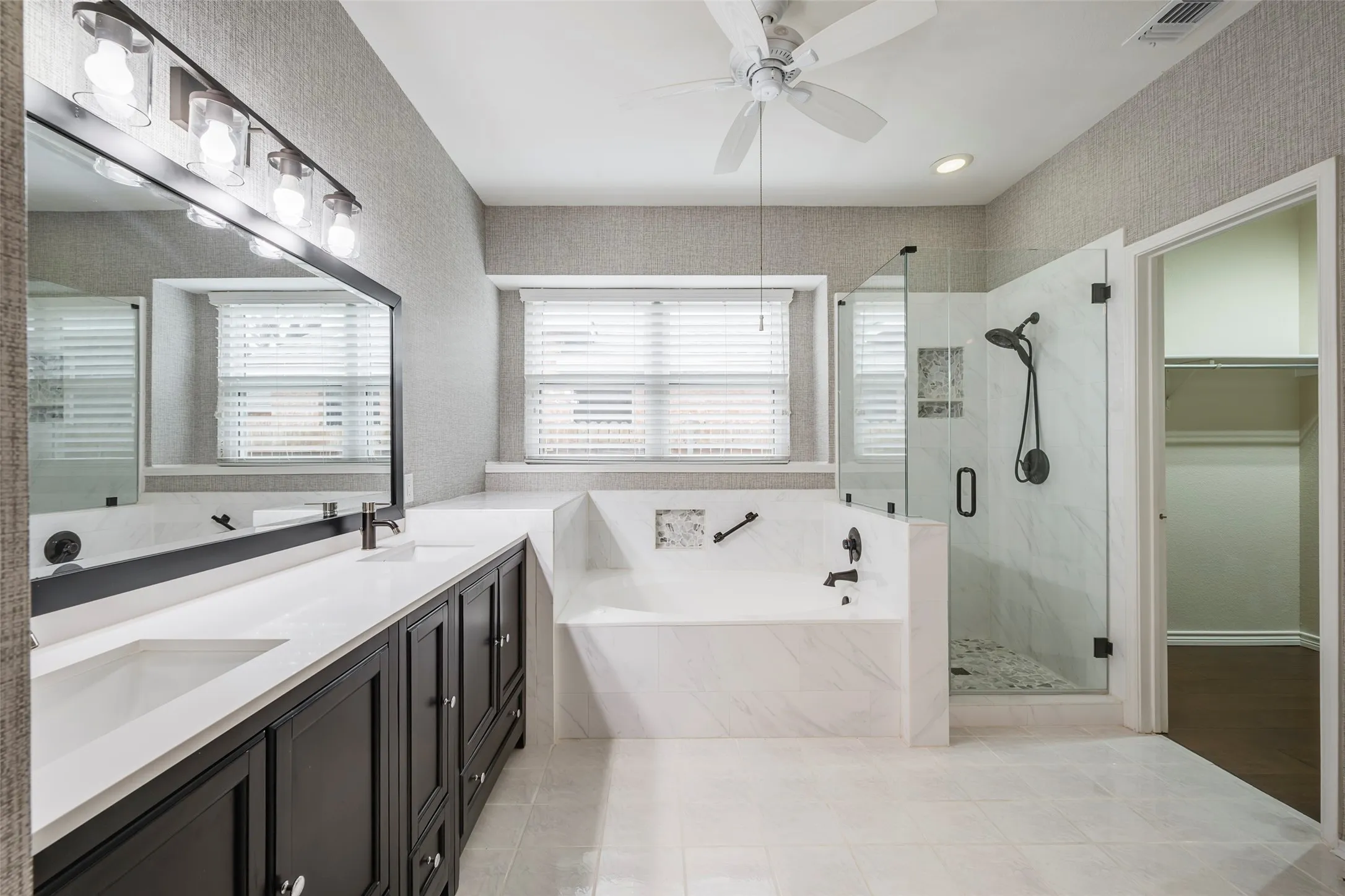 Spacious and updated primary ensuite bathroom with garden tub and walk in closet