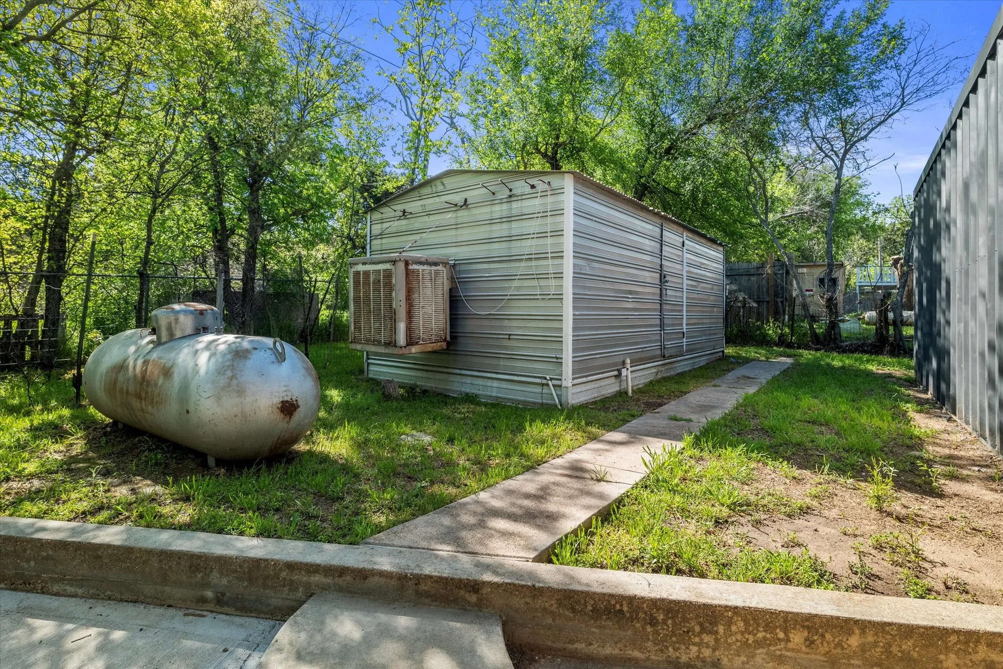 View of shed with a fenced backyard