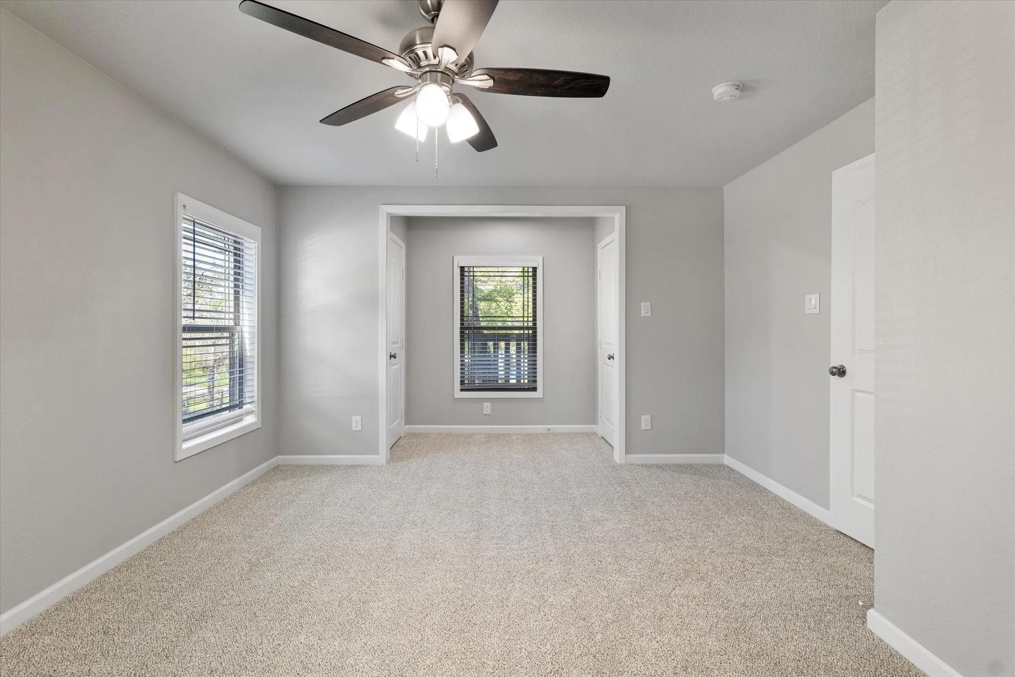Spare room with light carpet and ceiling fan