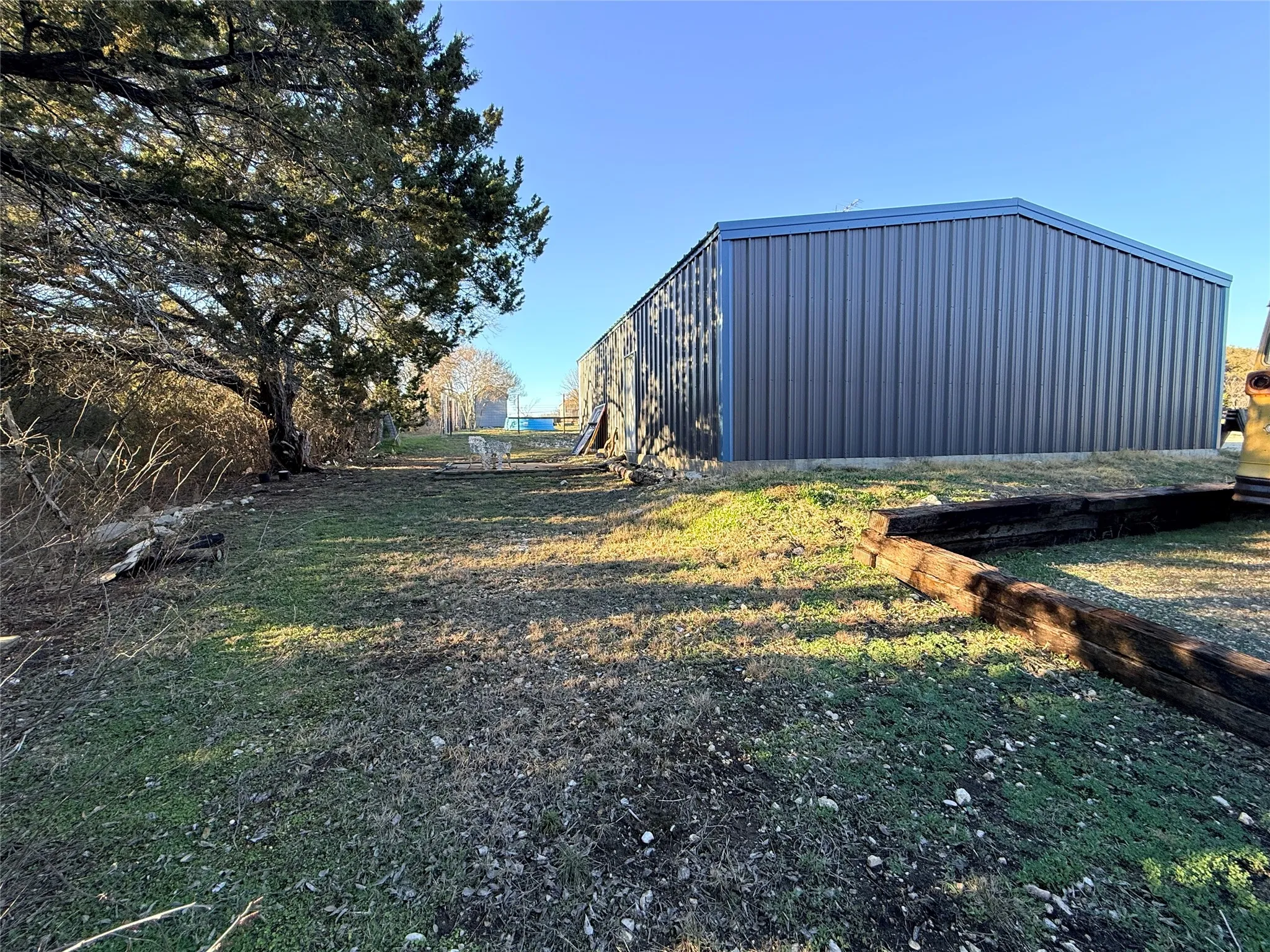 View of yard with a pole building and an outdoor structure