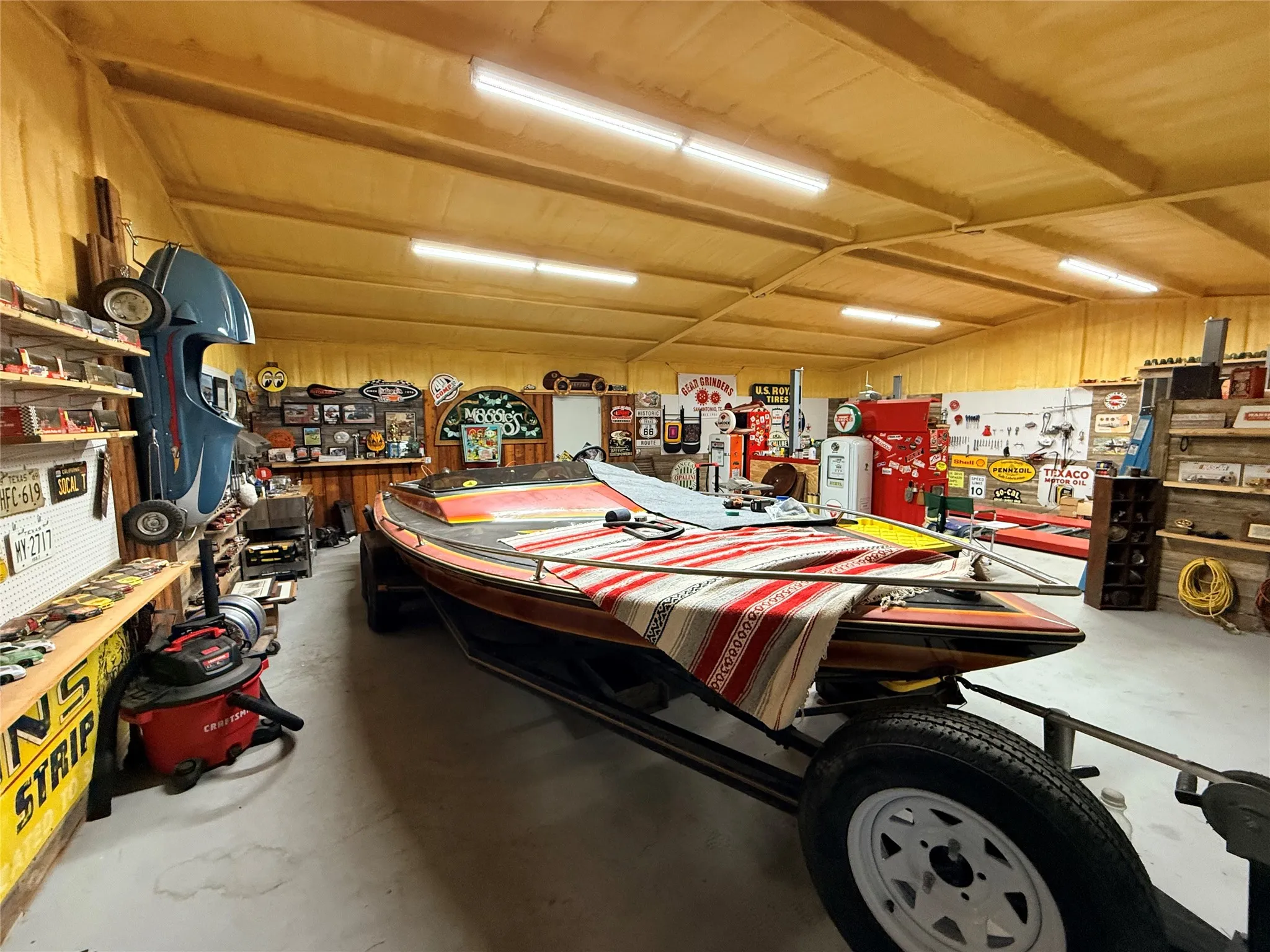 Miscellaneous room featuring a workshop area, concrete flooring, and vaulted ceiling