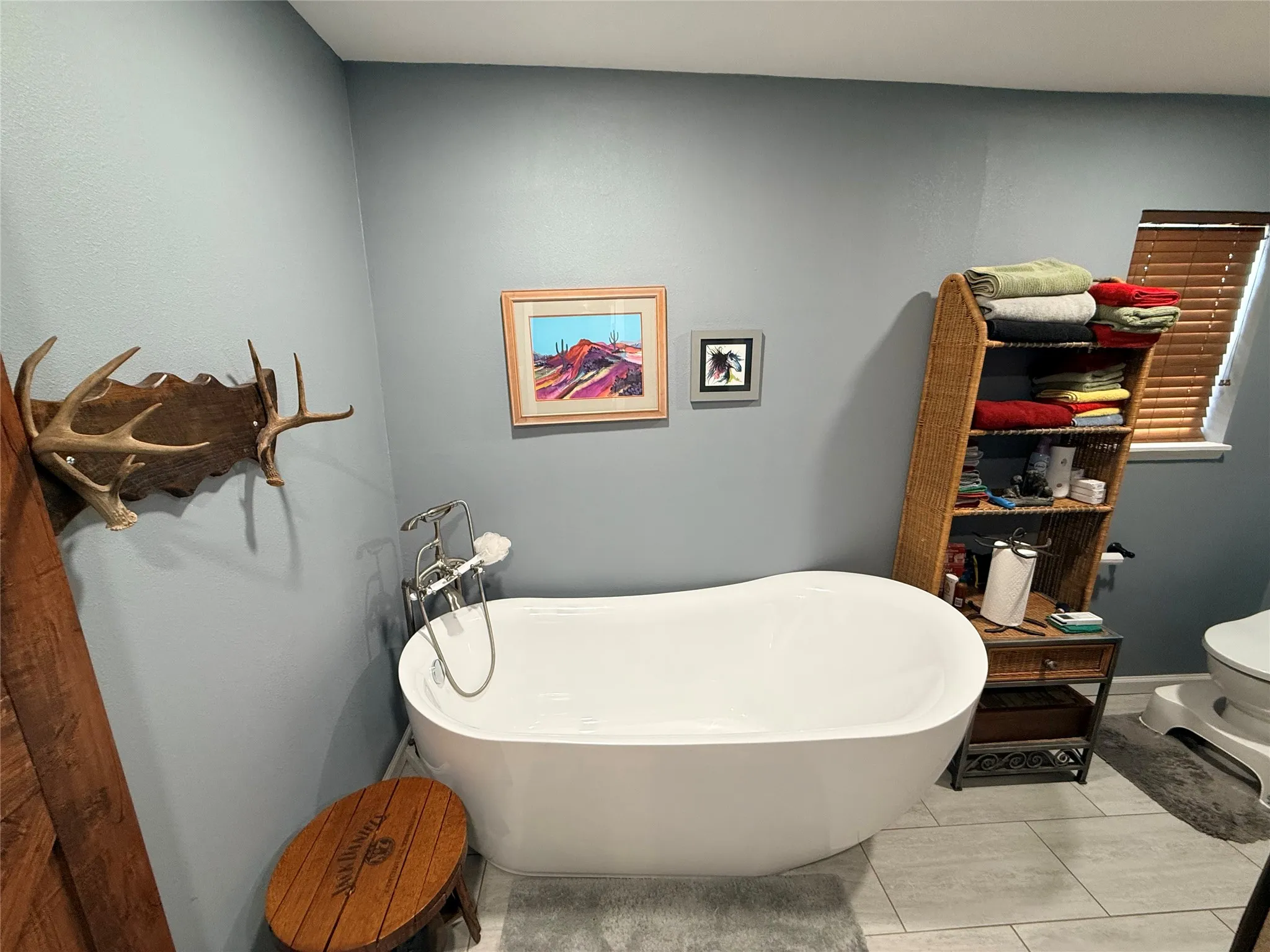 Bathroom featuring toilet and a freestanding tub