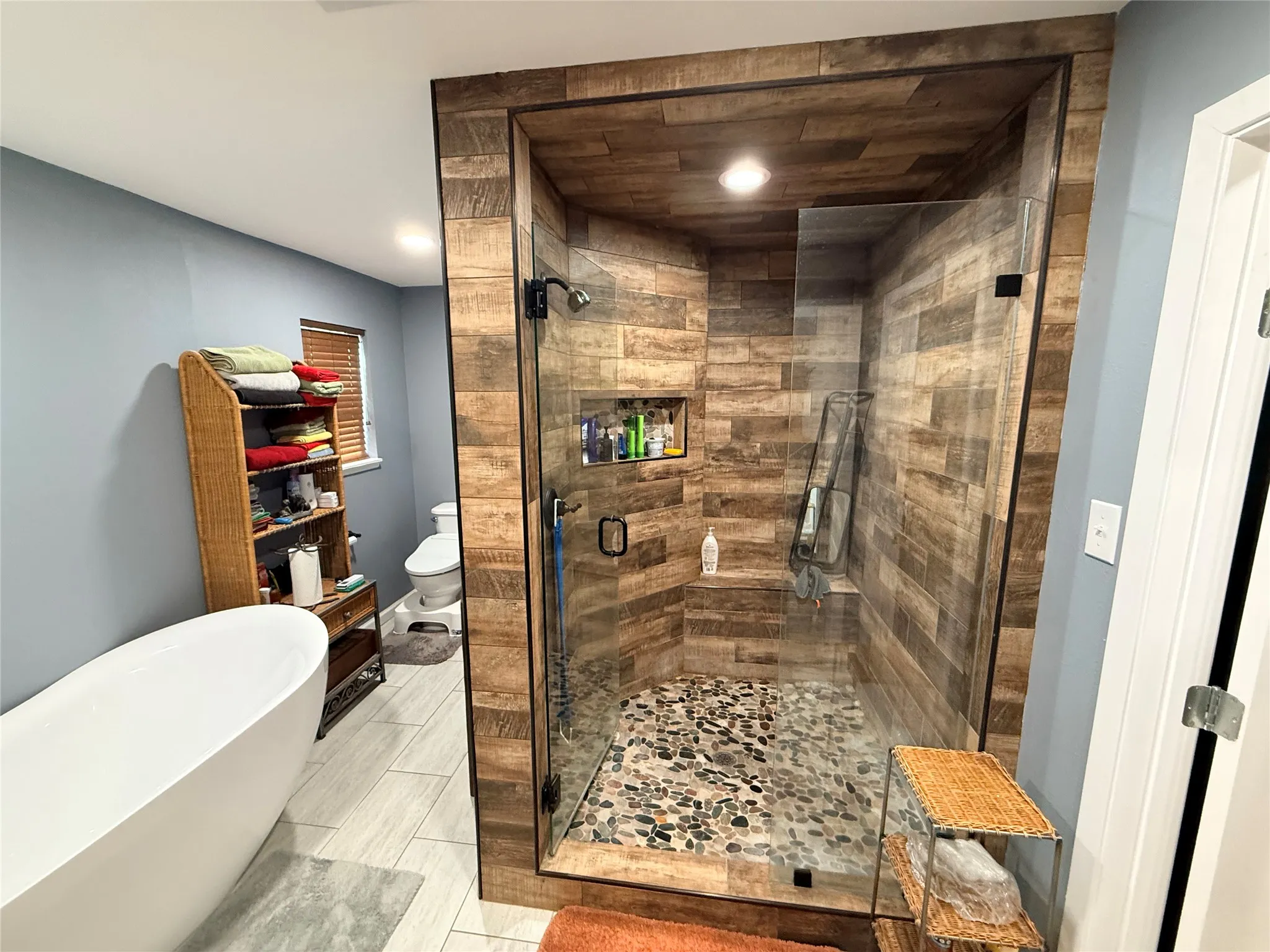 Full bathroom with a stall shower and a soaking tub
