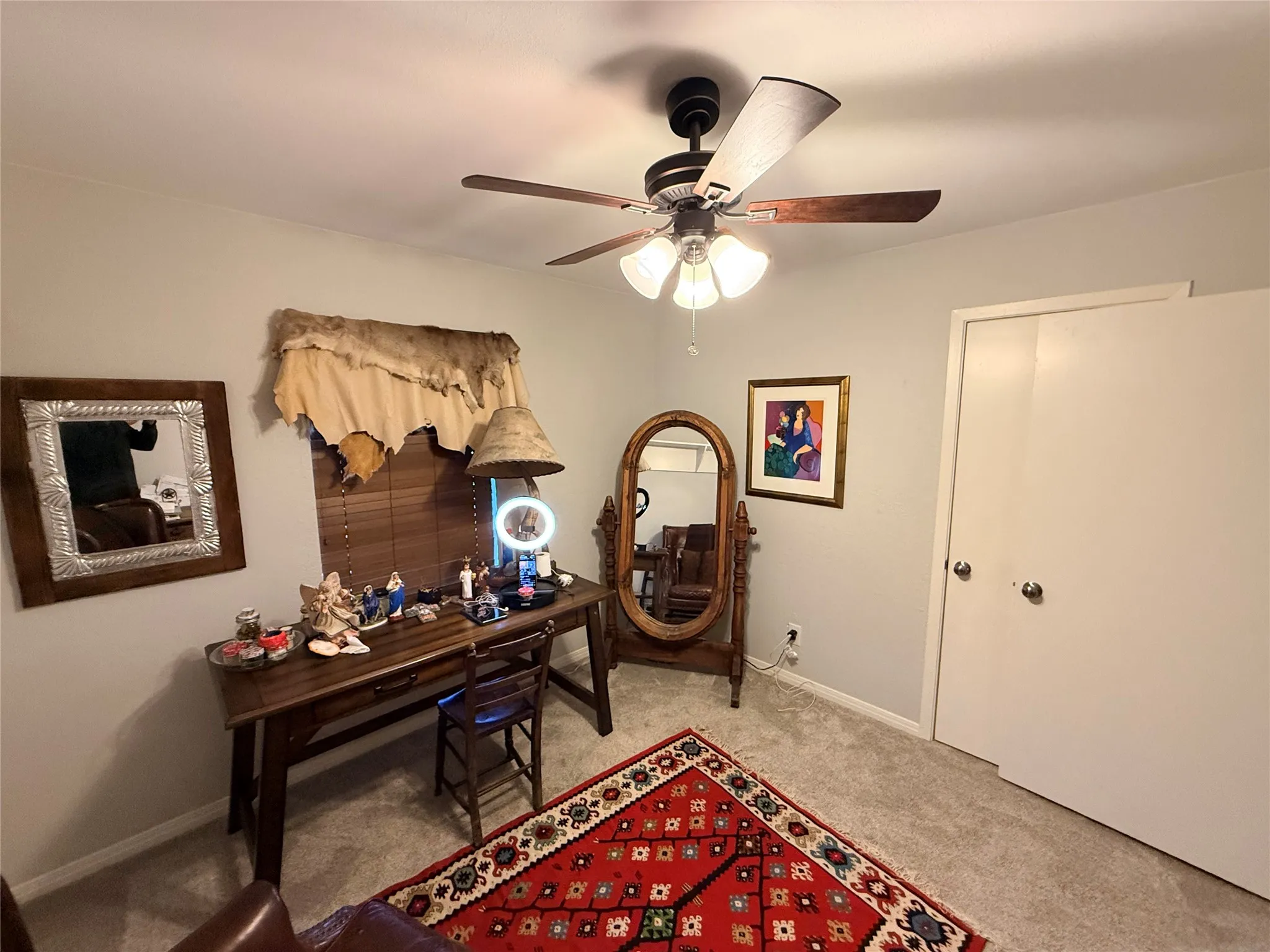 Office space featuring carpet and a ceiling fan