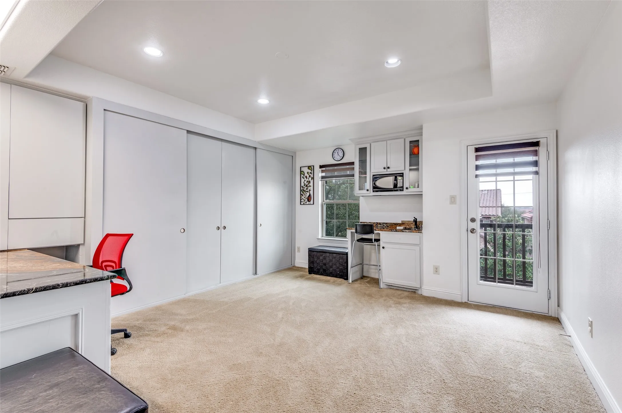 Upstairs bonus room with built-in executive desk, wet bar, access to upstairs porch, and lots of storage space