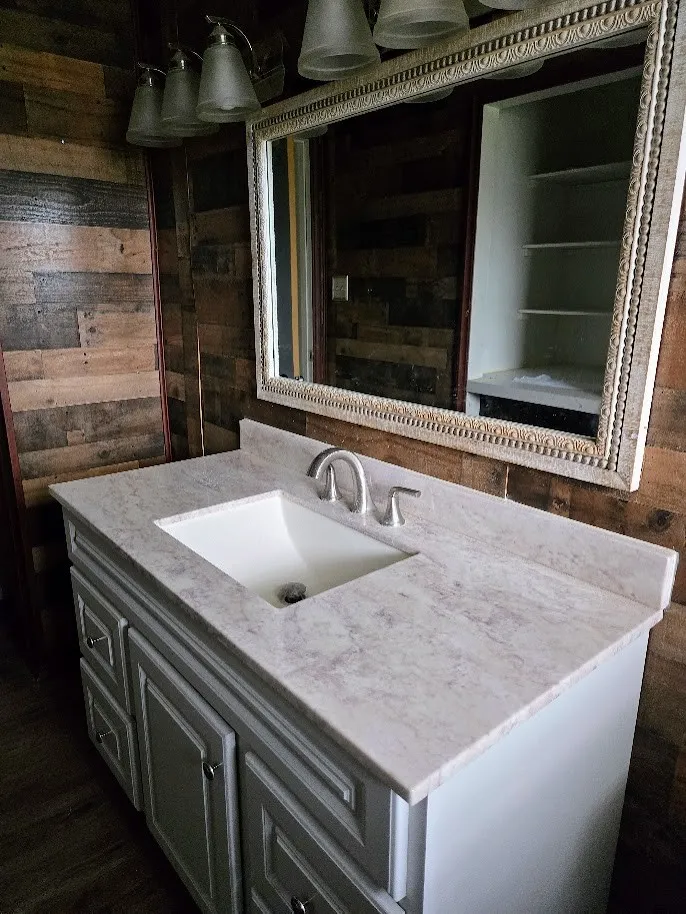 Bathroom featuring wood walls and vanity