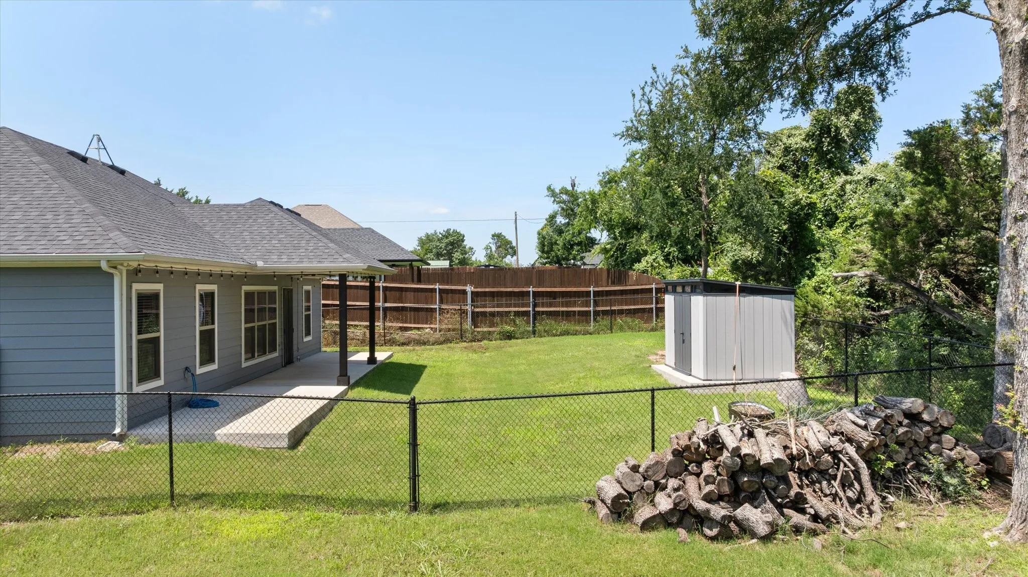 side view of back yard fenced area