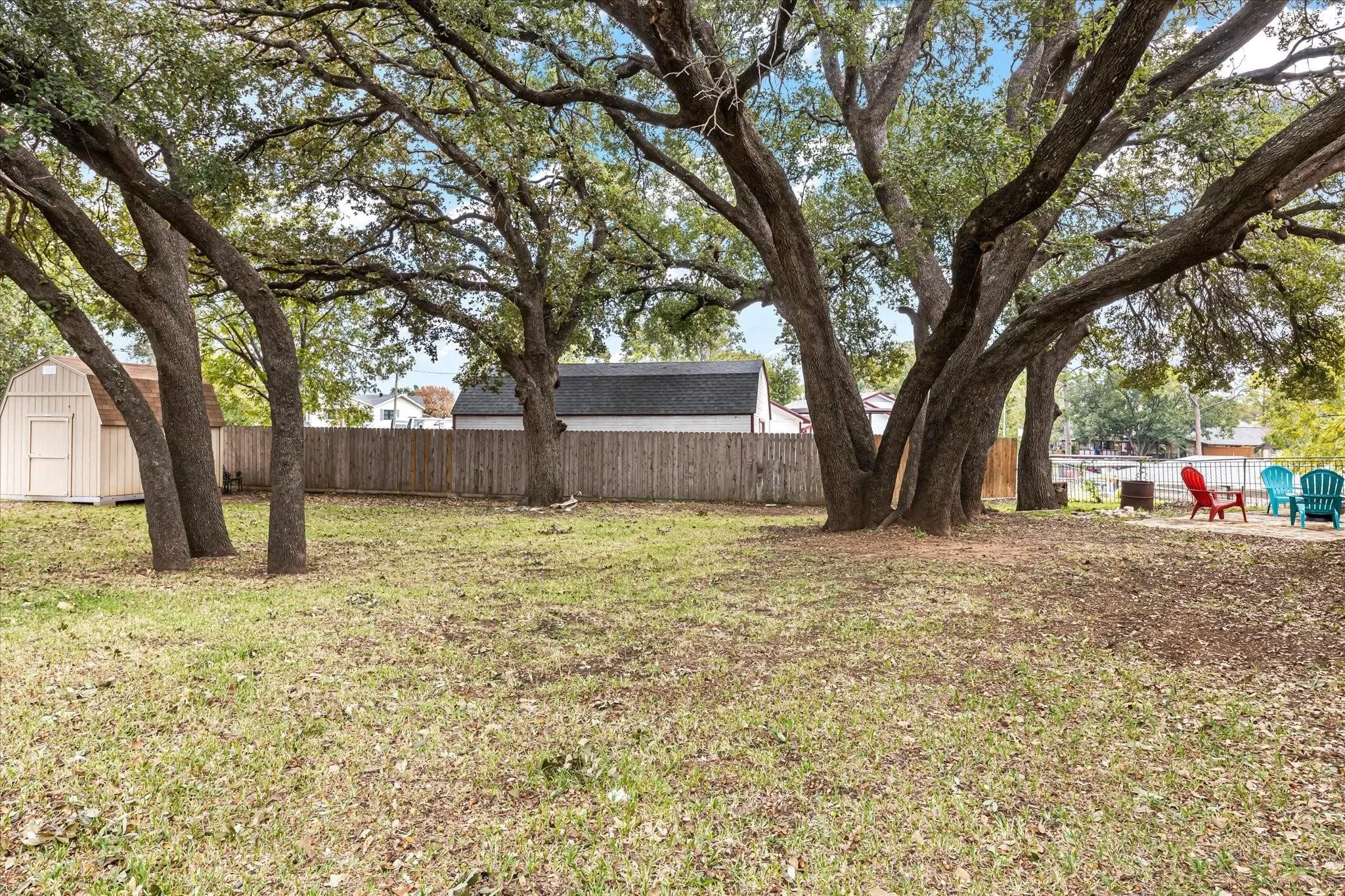 View of yard featuring a fenced backyard, an outdoor structure, and a storage unit