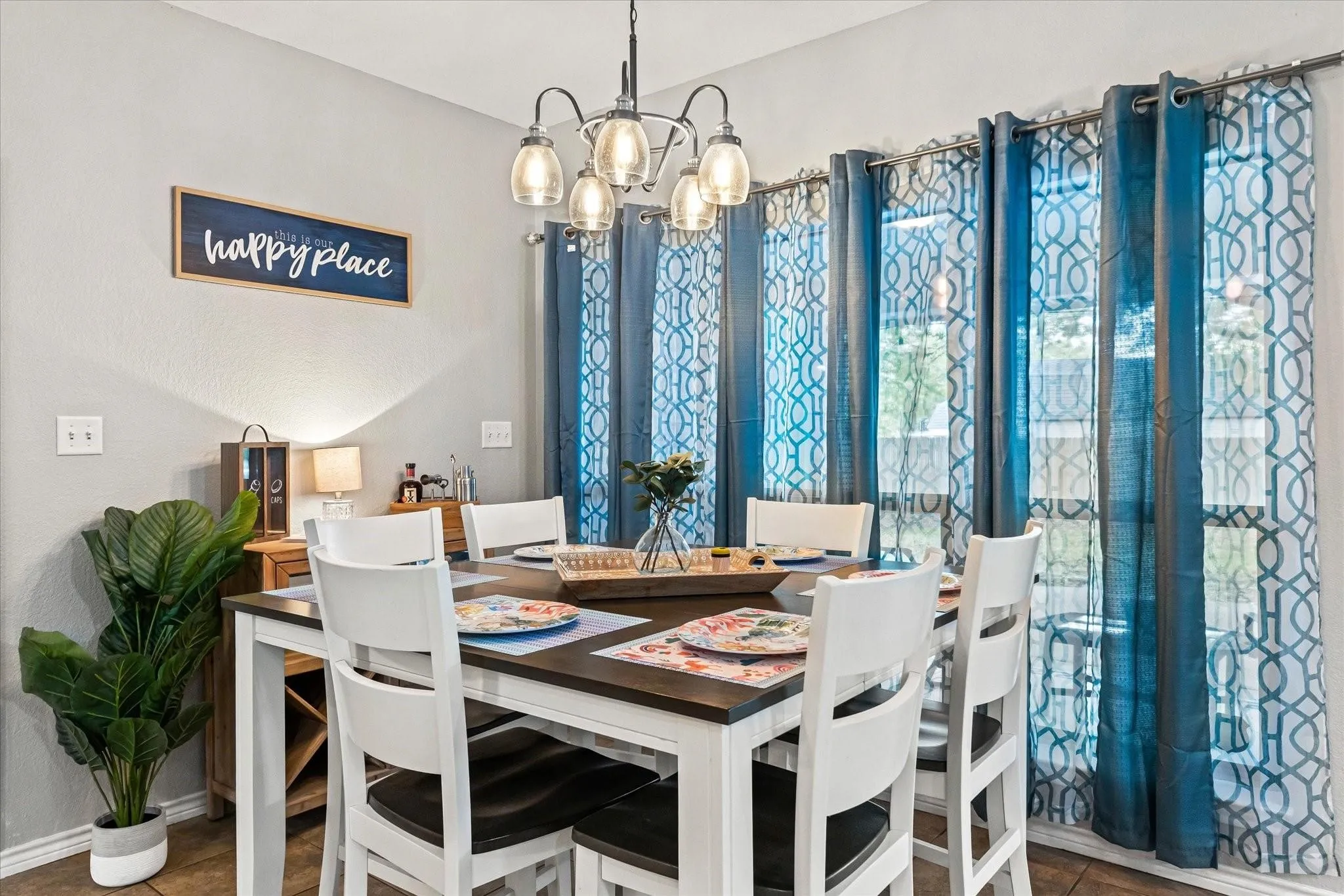 Dining area with baseboards and an inviting chandelier