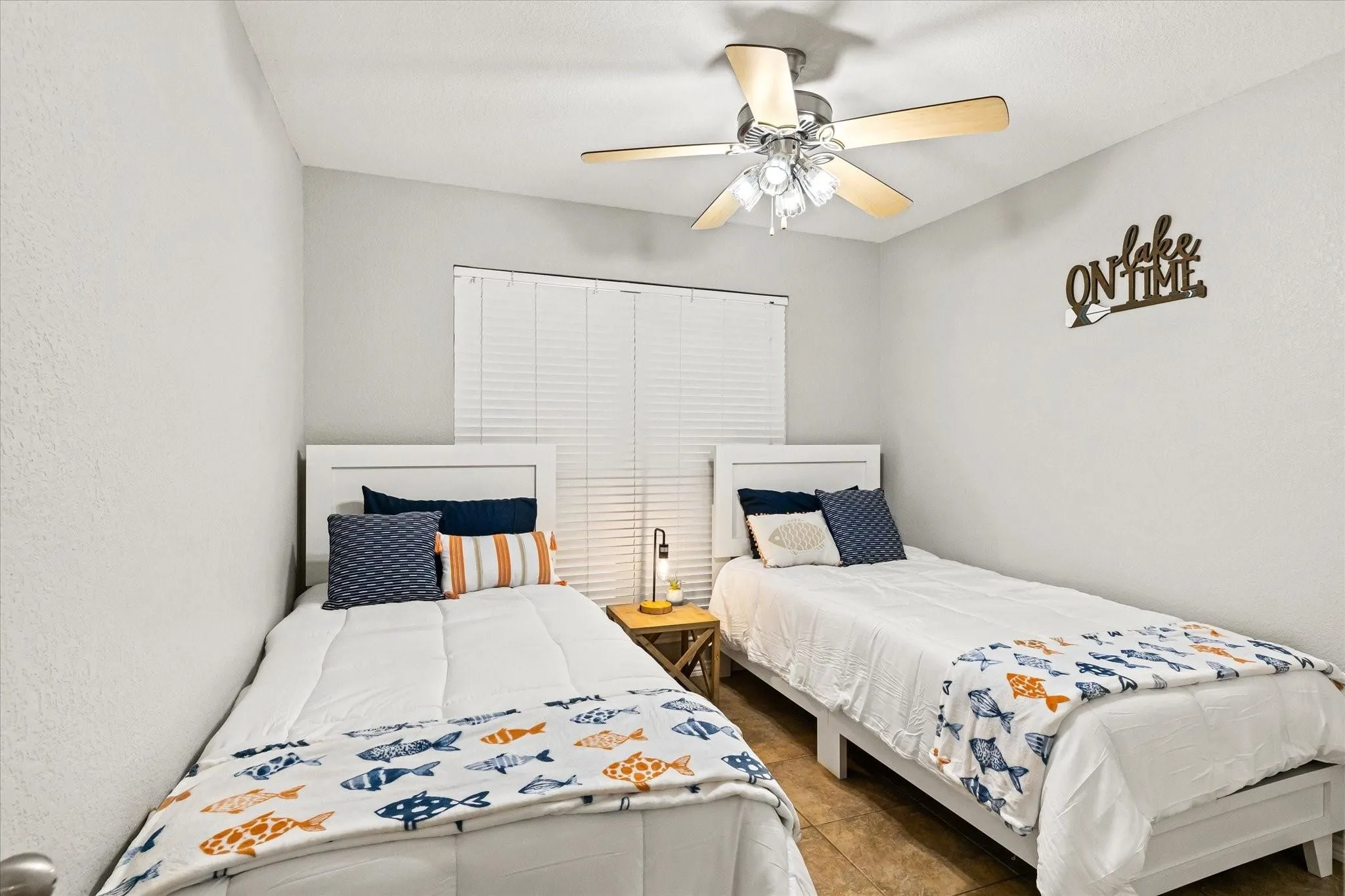 Bedroom with tile patterned floors and ceiling fan