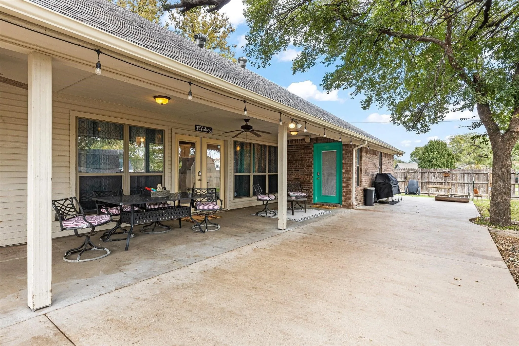 View of patio / terrace featuring french doors, grilling area, ceiling fan, and fence