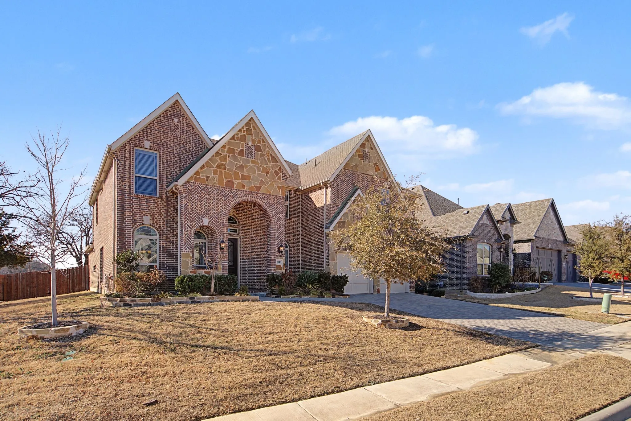 Tudor house featuring brick siding and driveway