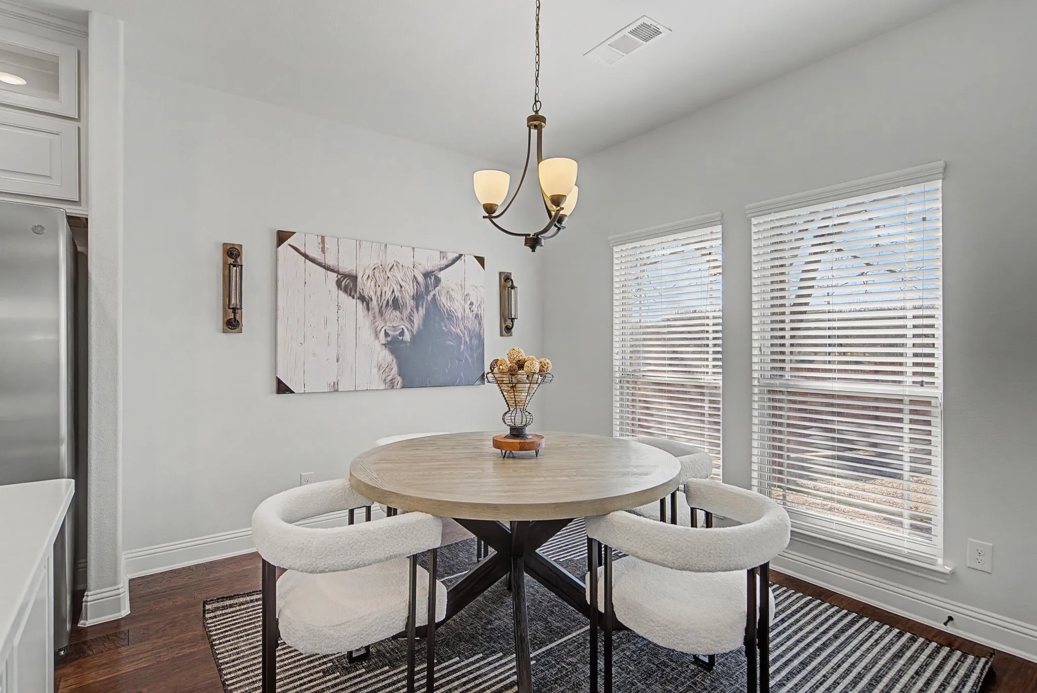 Dining room featuring dark wood-style floors and a chandelier