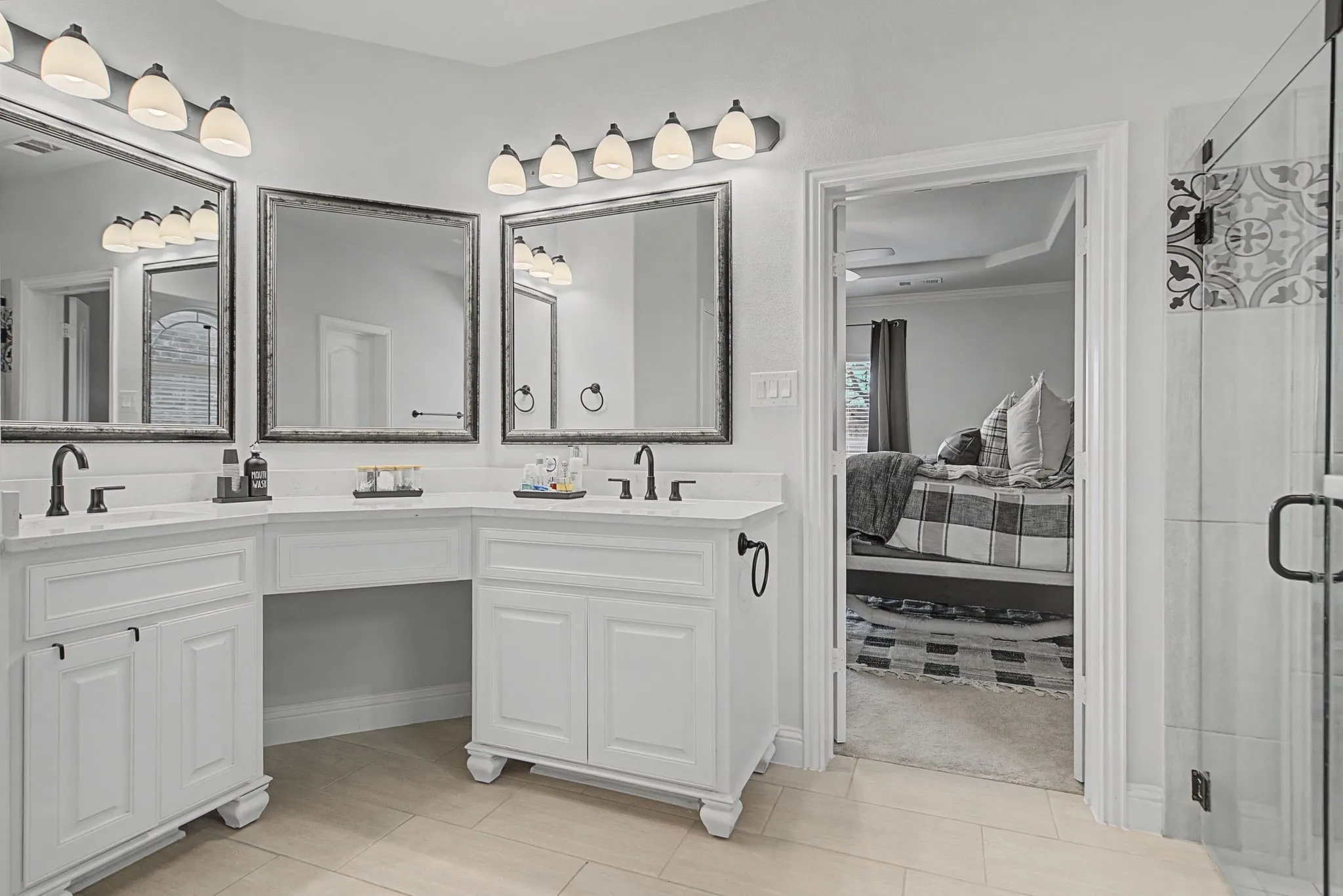 Full bathroom featuring double vanity and a stall shower