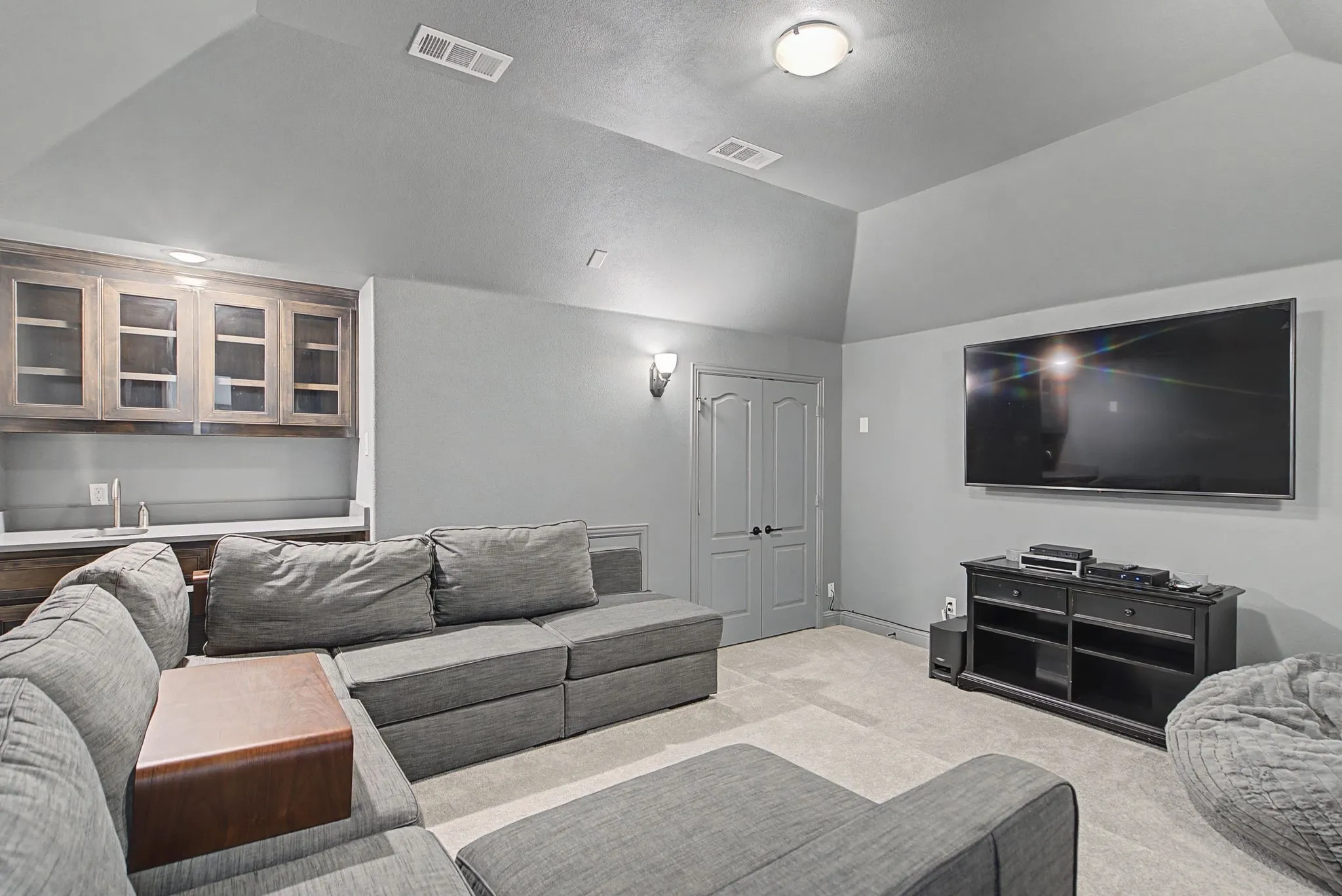Media Room featuring vaulted ceiling and carpet floors