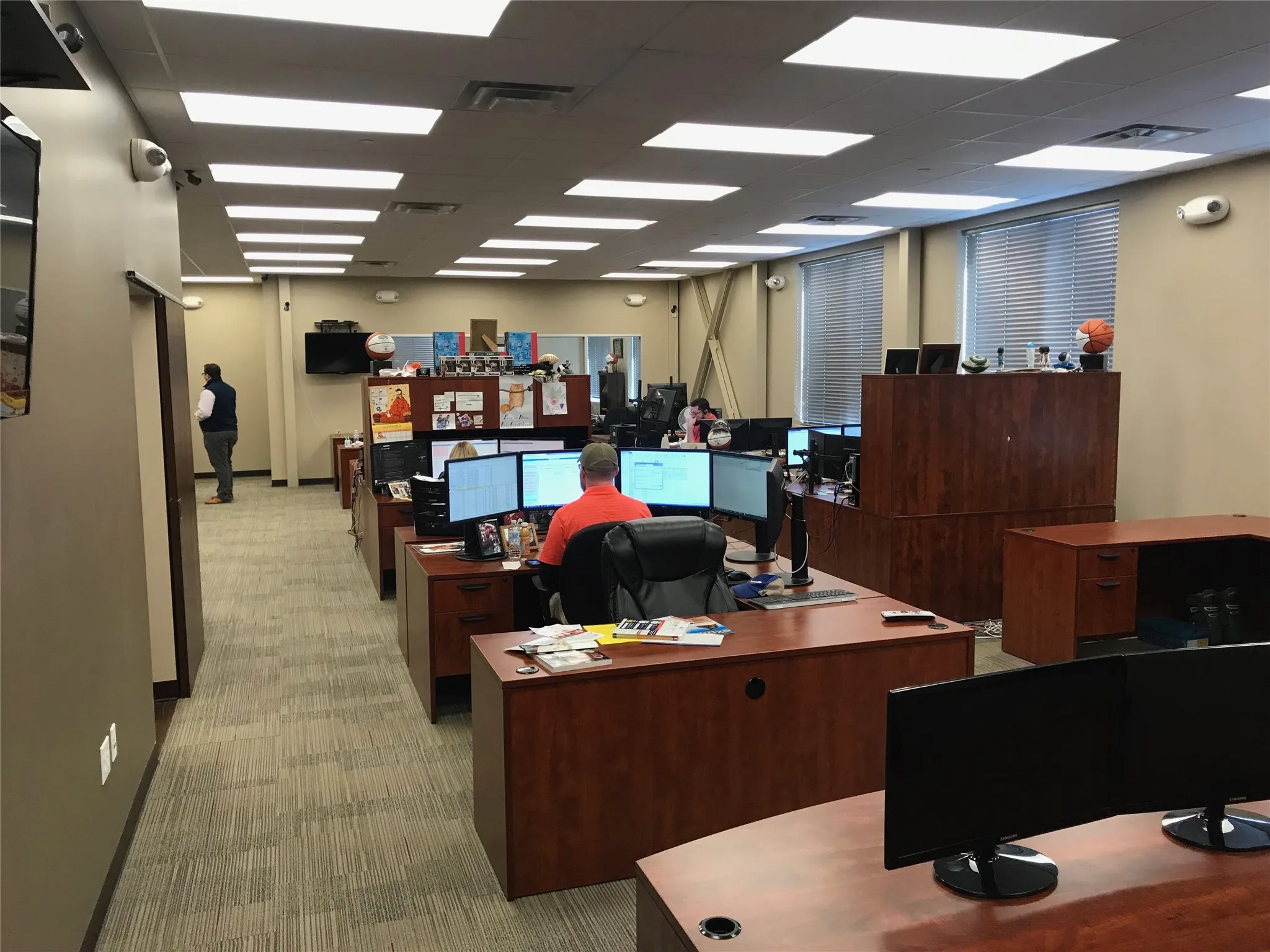Office with light colored carpet and a paneled ceiling