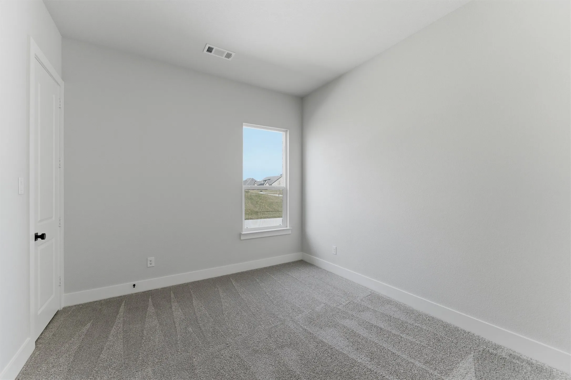 Unfurnished bedroom featuring light colored carpet and baseboards