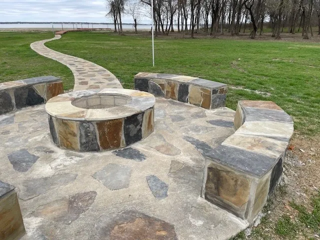 View of patio with a fire pit at community center