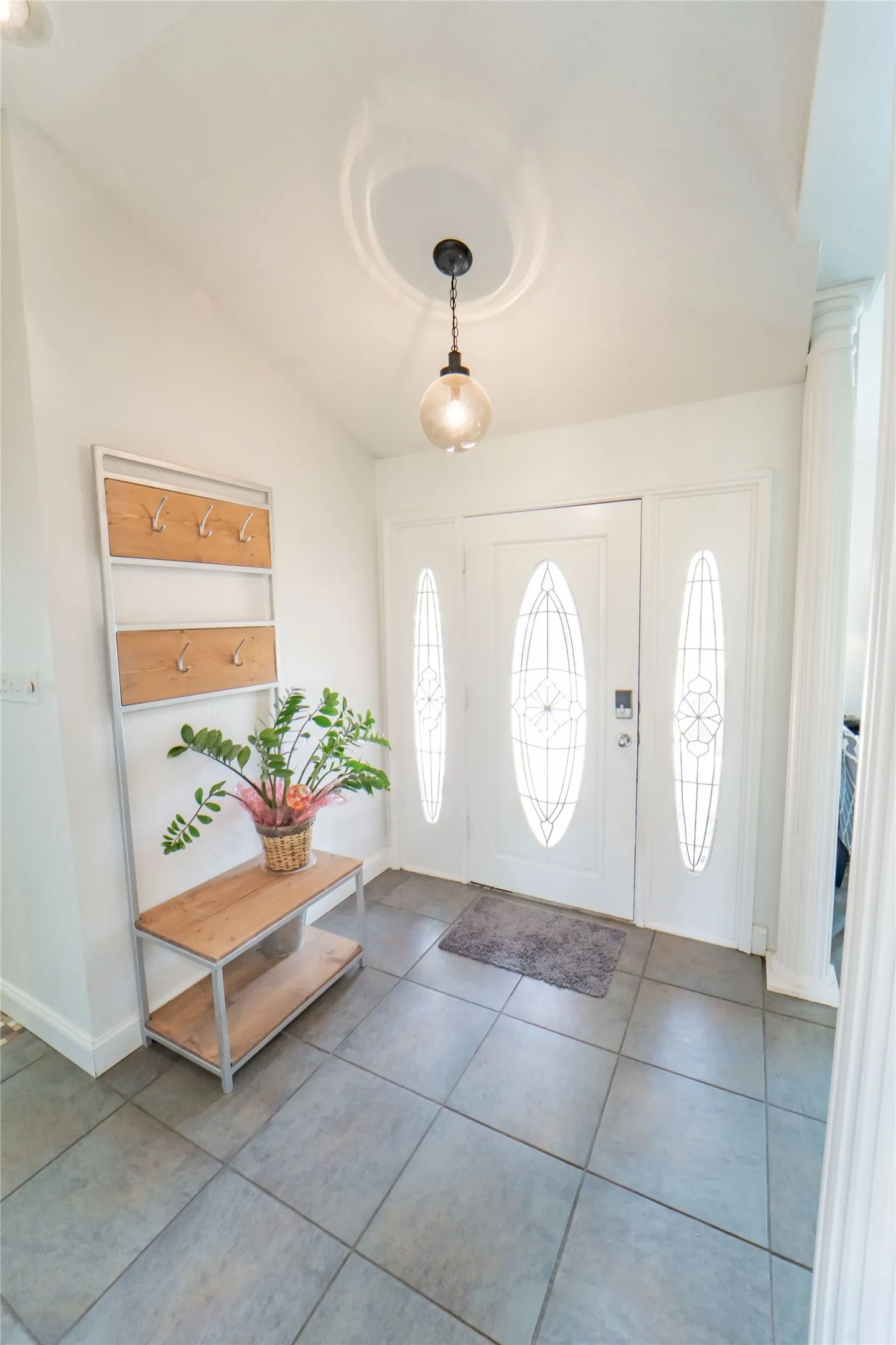 Welcoming foyer opens into open concept floor plan-