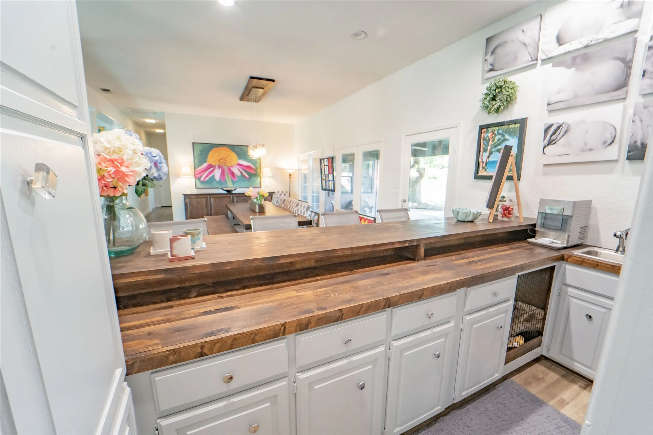 Wet bar access, conveniently located adjacent to kitchen-built-ins and added storage are a hostess's dream!