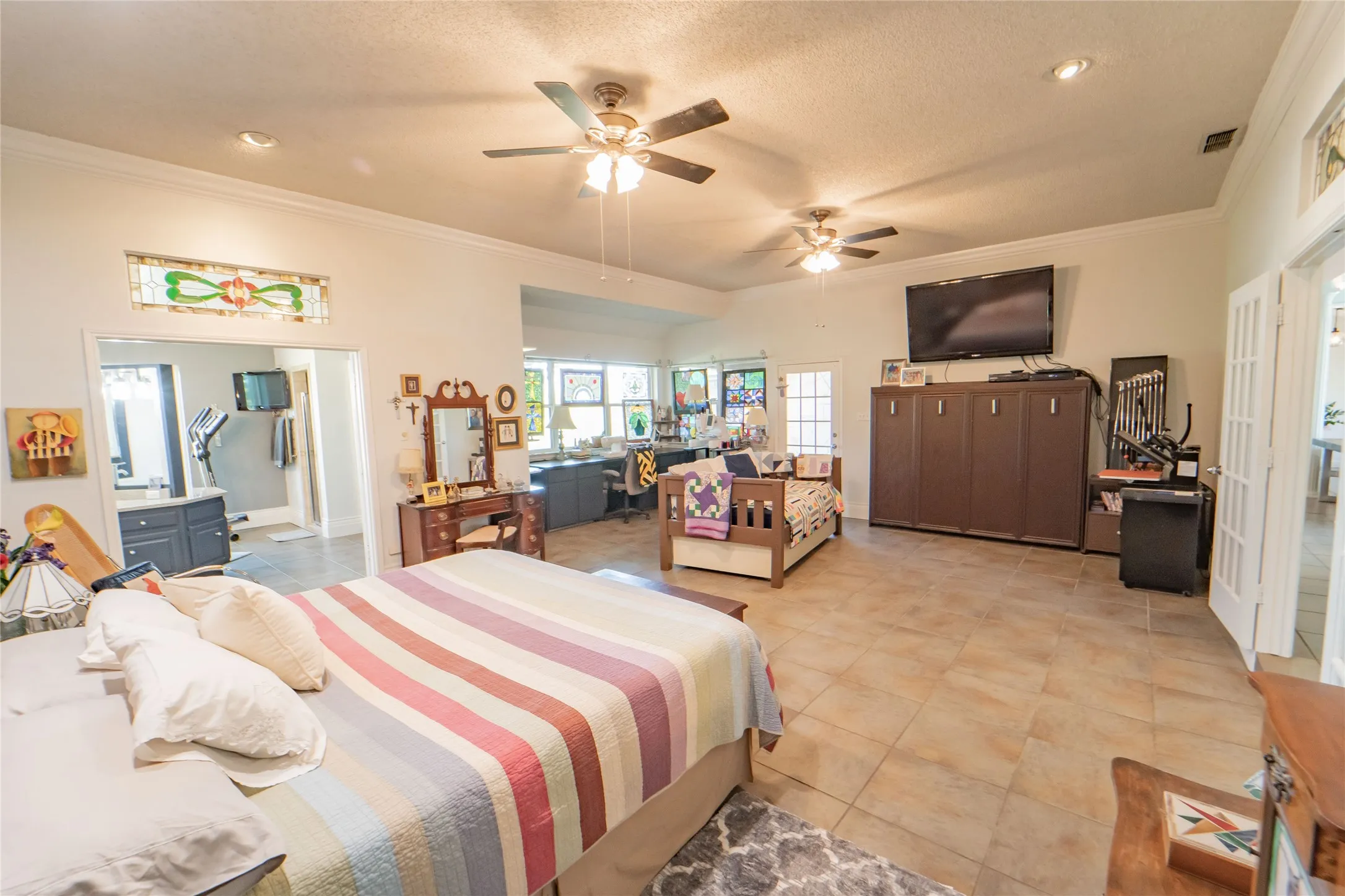 Spacious Primary En-Suite, built-ins, sitting area and access to covered patio for enjoying morning coffee!