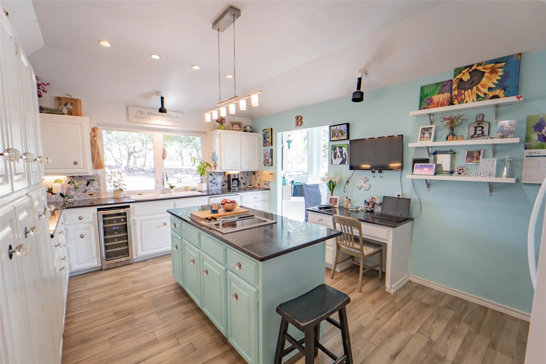 Kitchen offers a center island with cooktop, breakfast bar option, pendant lighting and lofted ceiling, beverage cooler-AND views to the outdoor pavilion and pool!