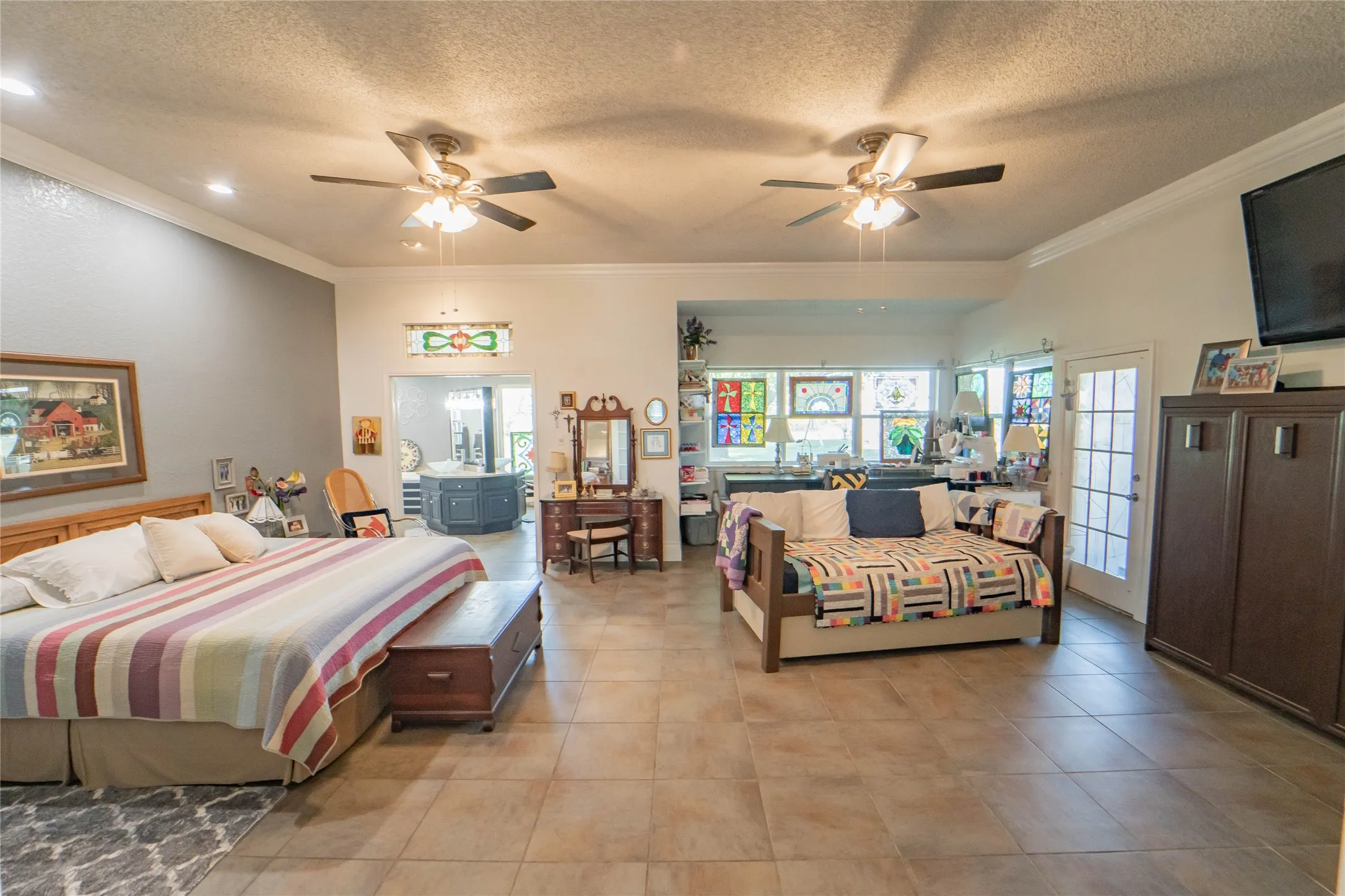 Spacious Primary En-Suite, built-ins, sitting area and private access to covered patio-