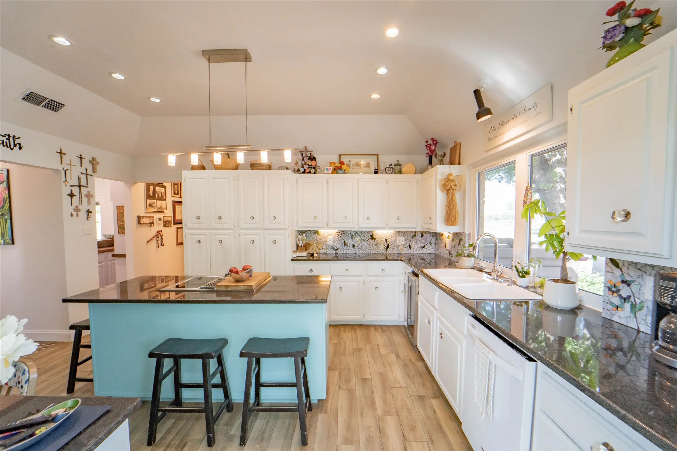 Kitchen offering all the amenities, ample cabinets for storage, a breakfast bar, and lofted ceiling-great natural lighting with outdoor views!