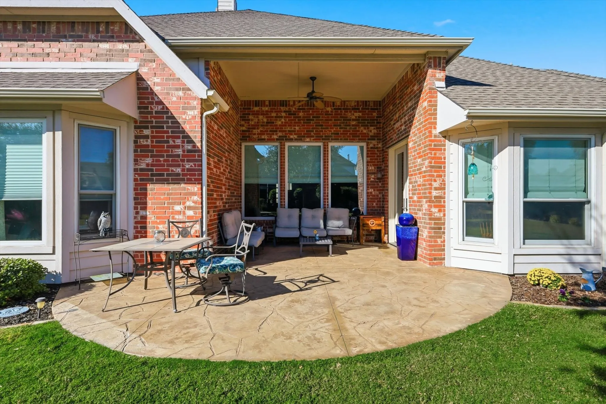 View of extended patio with a ceiling fan and an outdoor living space