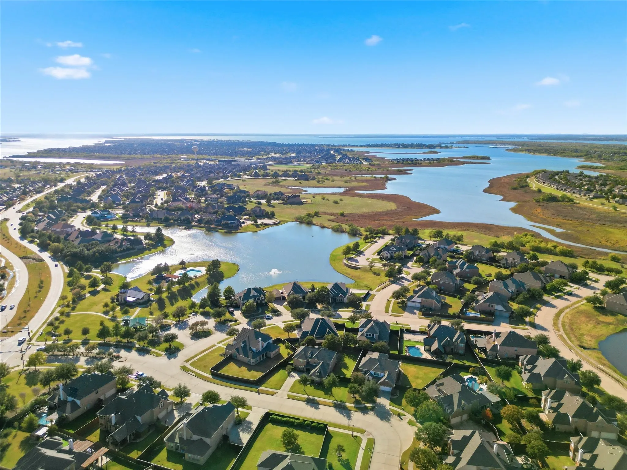 Aerial overview of property's location featuring a large body of water and nearby suburban area