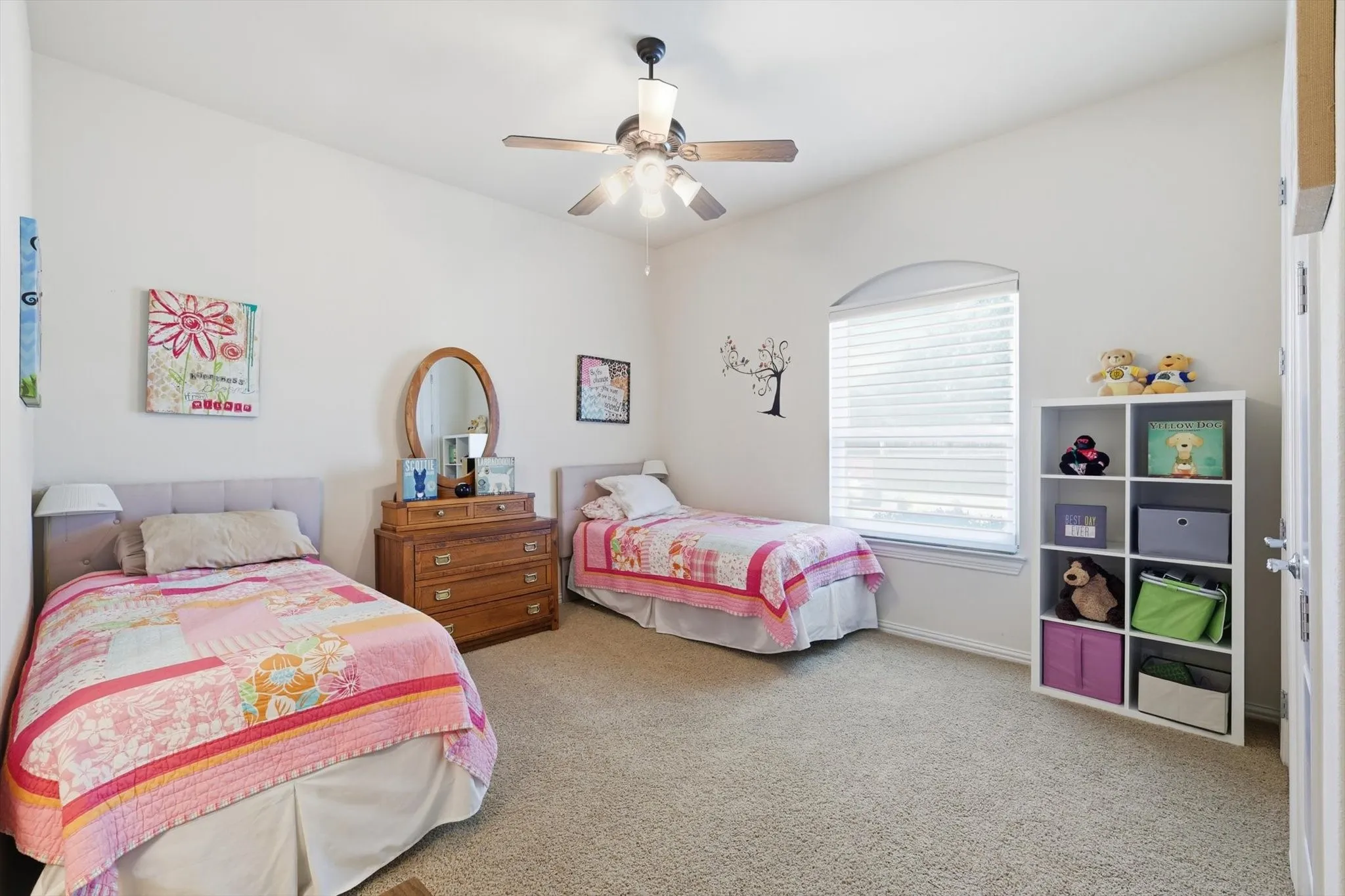 Carpeted bedroom with a ceiling fan and Closet