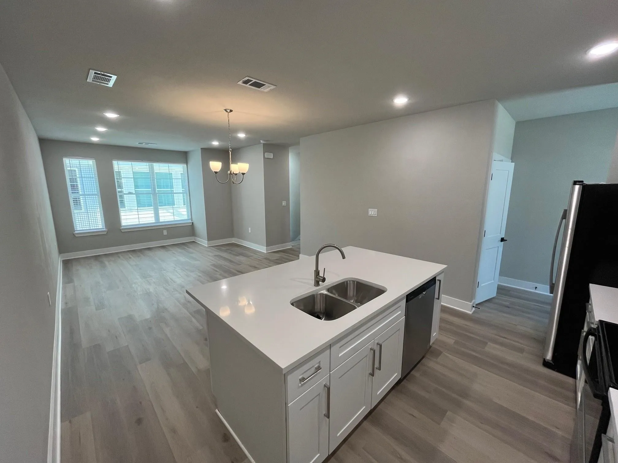 Kitchen and living space in the 3 bedroom unit with 10 foot ceilings, granite counter tops and light and brigh