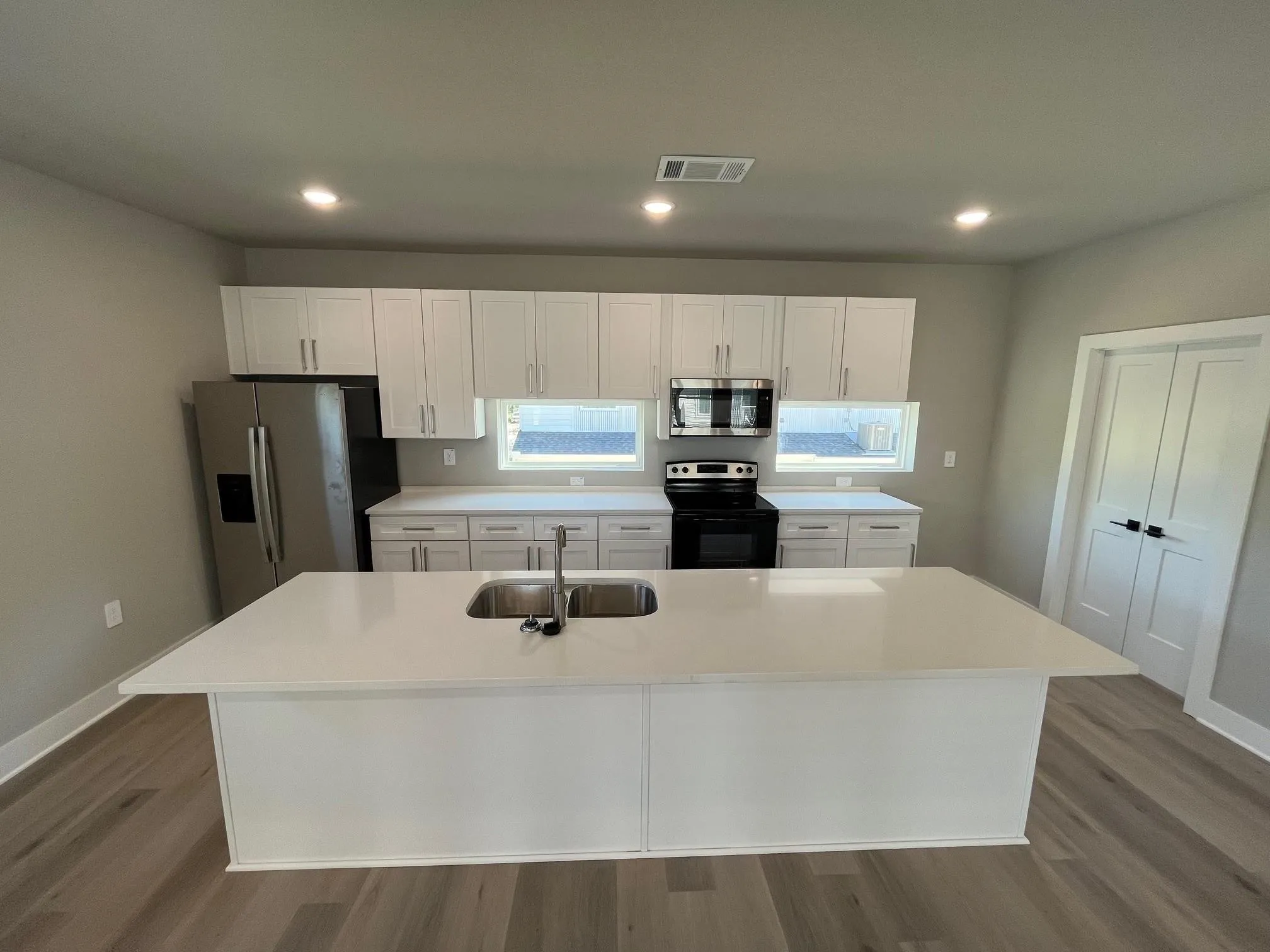 Kitchen in 4 bedroom unit with great windows, separate utility area, and hard surface flooring